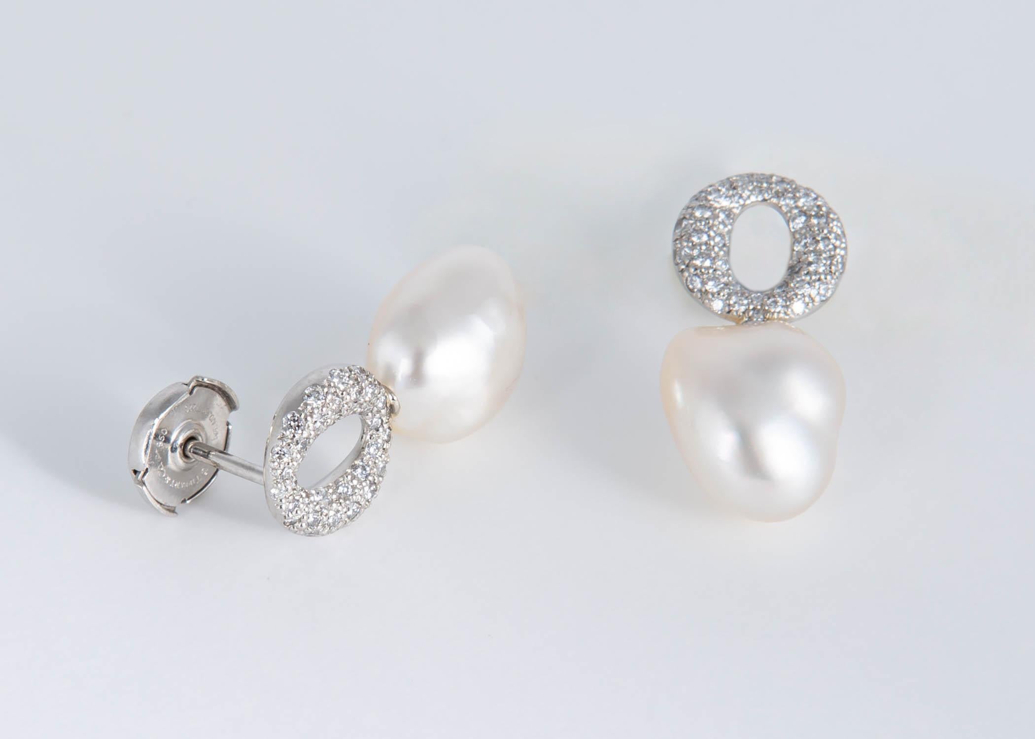 Elsa Peretti has created pure simple designs that are todays classics. This pair of earrings begin with pure platinum and brilliant cut diamonds and feature rare keshi pearls. Keshi pearls are natural and a rare gift of nature. This wearable unique