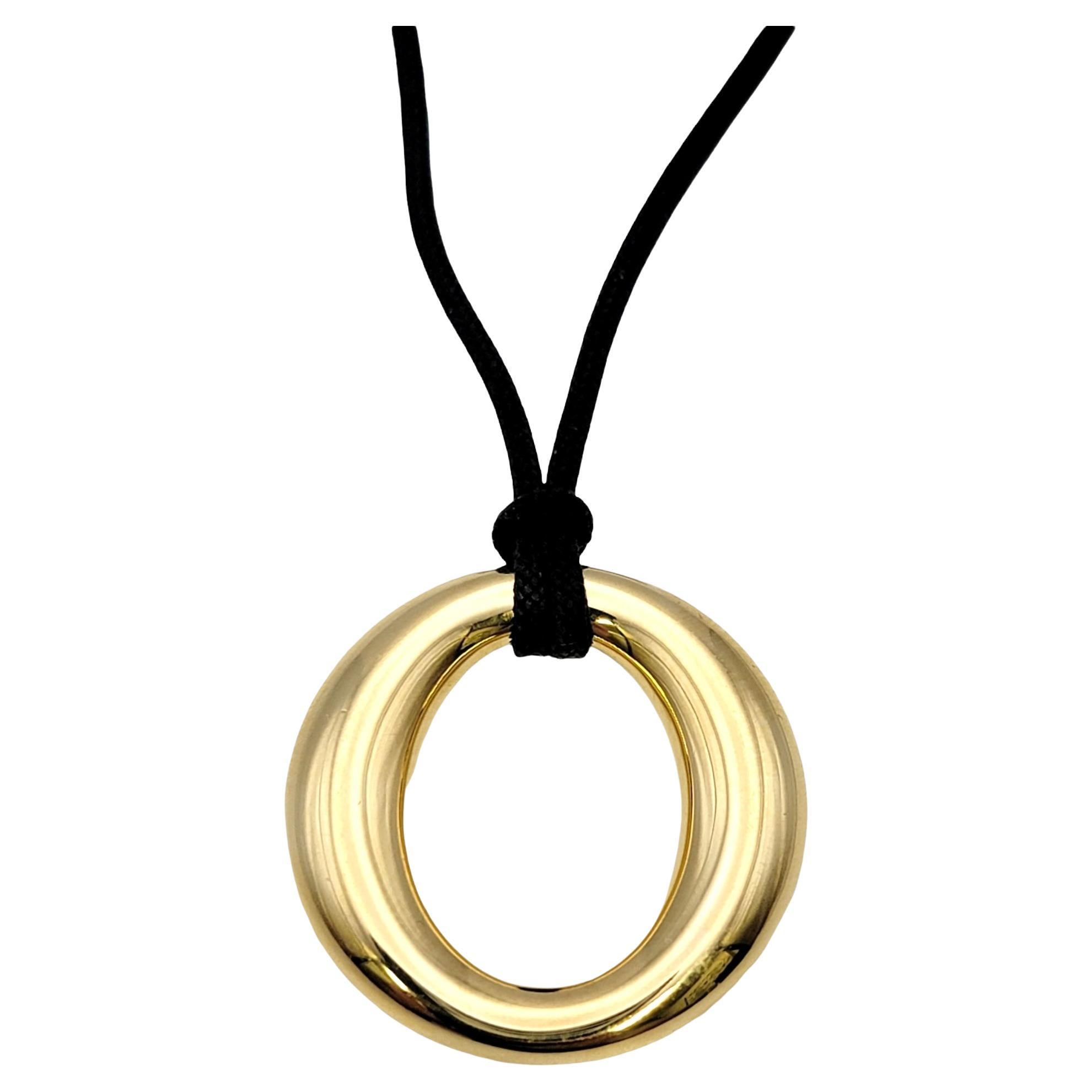 This chic Sevillana pendant necklace by Elsa Peretti for Tiffany & Co. exudes minimalist elegance. The modern 18 karat gold design combined with the sleek black silk cord makes for a piece that you will never want to take off!

Metal: 18K Yellow