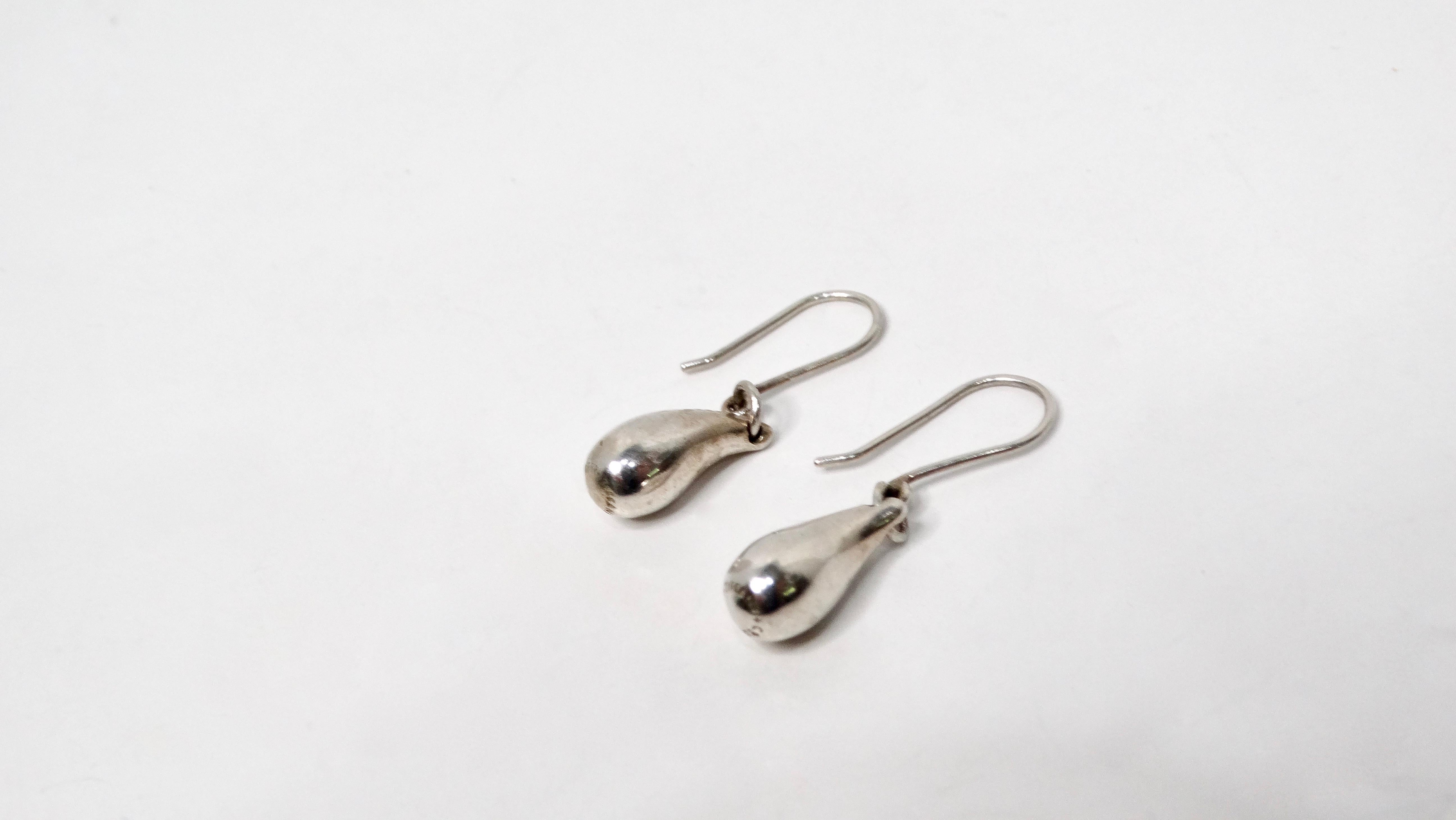 Elsa Peretti for Tiffany & Co. Vintage Sterling Silver Teardrop Earrings exemplify timeless elegance and sophisticated simplicity. Crafted from high-quality sterling silver, these earrings feature a minimalist teardrop shape that exudes understated