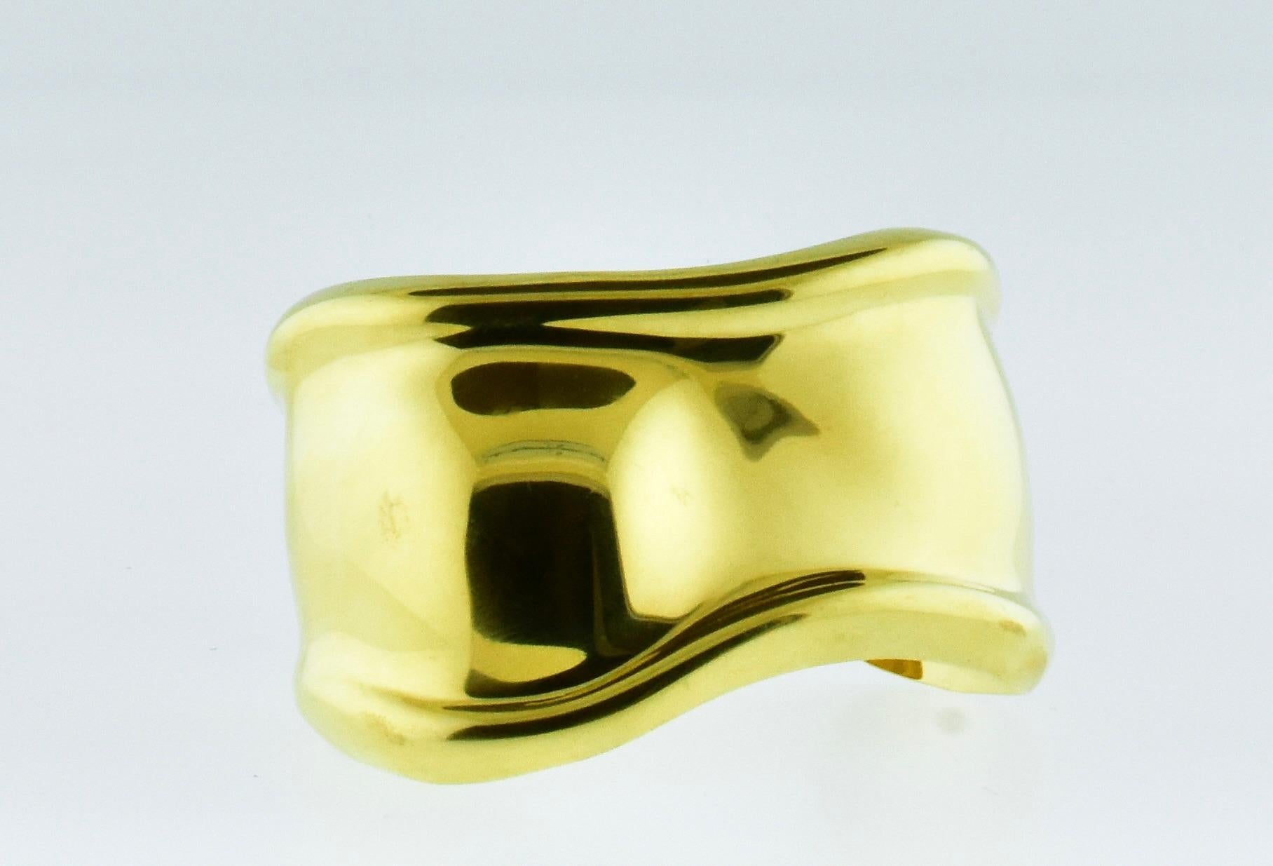 Elsa Peretti for Tiffany & Co. Bone Cuff.  18K yellow gold, vintage in fine condition.  This is the size medium which is 61 mm. (measuring from the outside of the piece laterally as it lays across the wrist). This cuff is in fine condition.  Because