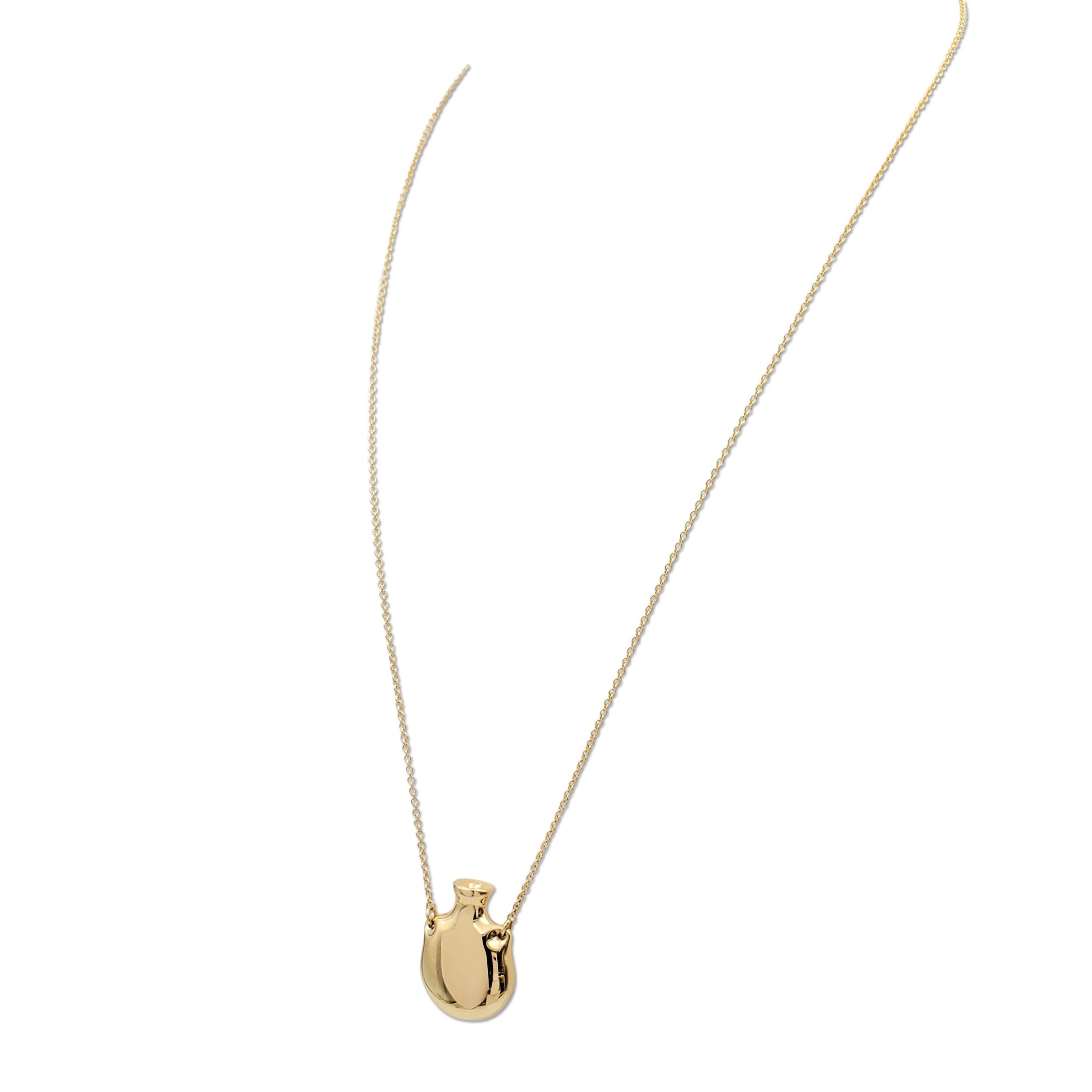 Authentic Elsa Peretti for Tiffany & Co. open bottle necklace crafted in 18 karat yellow gold. Signed Tiffany & Co., Elsa Peretti, 750 Spain. The necklace chain measures 24 inches in length. The pendant measures 29 x 22 mm. The bottle is open and