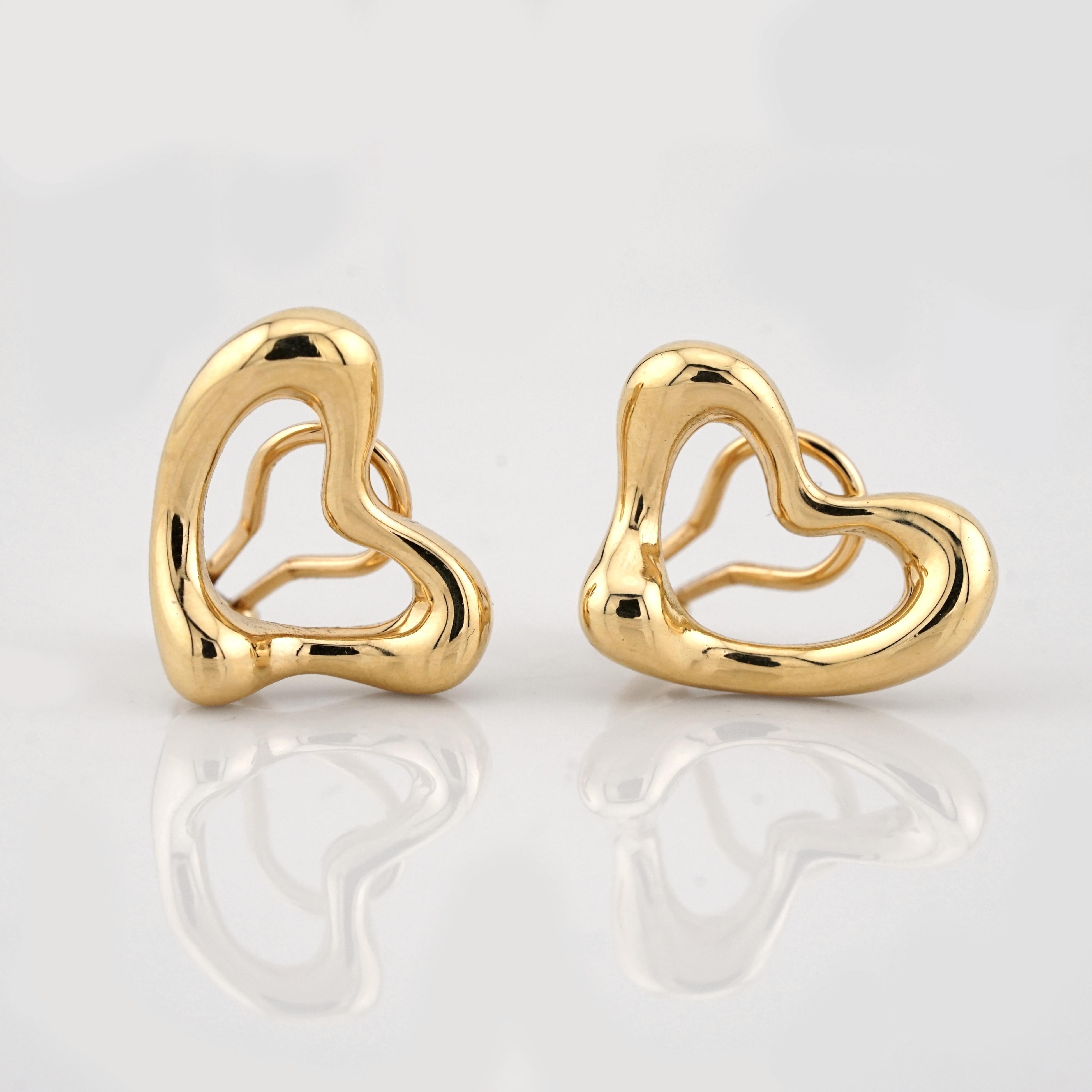 These elegant Elsa Peretti Open Heart earrings for Tiffany & Co. are crafted in 18K yellow gold, showcasing the iconic, fluid design that embodies timeless sophistication. The large model features bold, sculptural lines that create a striking yet