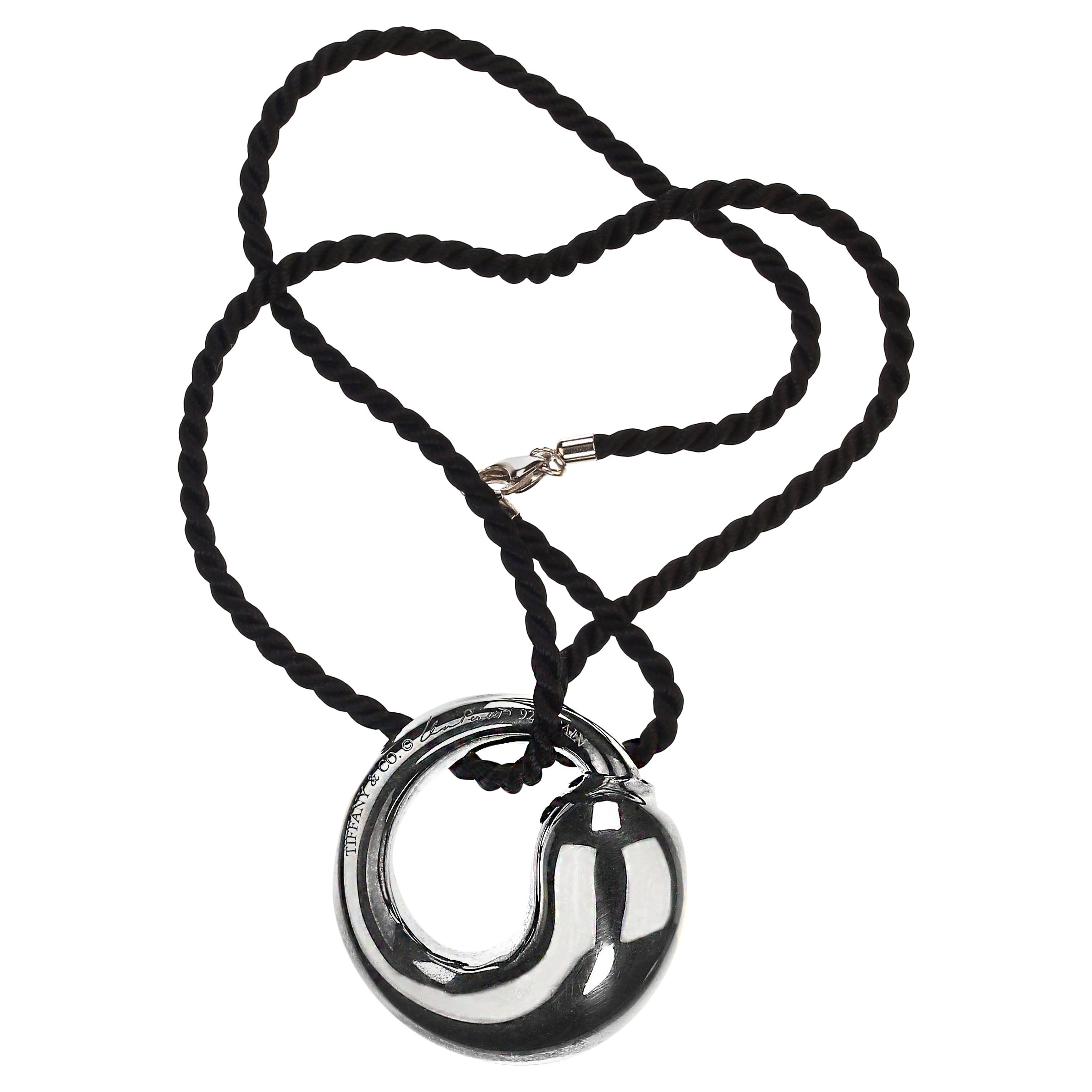 Timeless Elsa Peretti Sterling Silver Eternal Circle Pendant – Elegant Design with 16-Inch Black Cord
Add a touch of elegance to your collection with this stunning Elsa Peretti Sterling Silver Eternal Circle Pendant, a classic piece that embodies