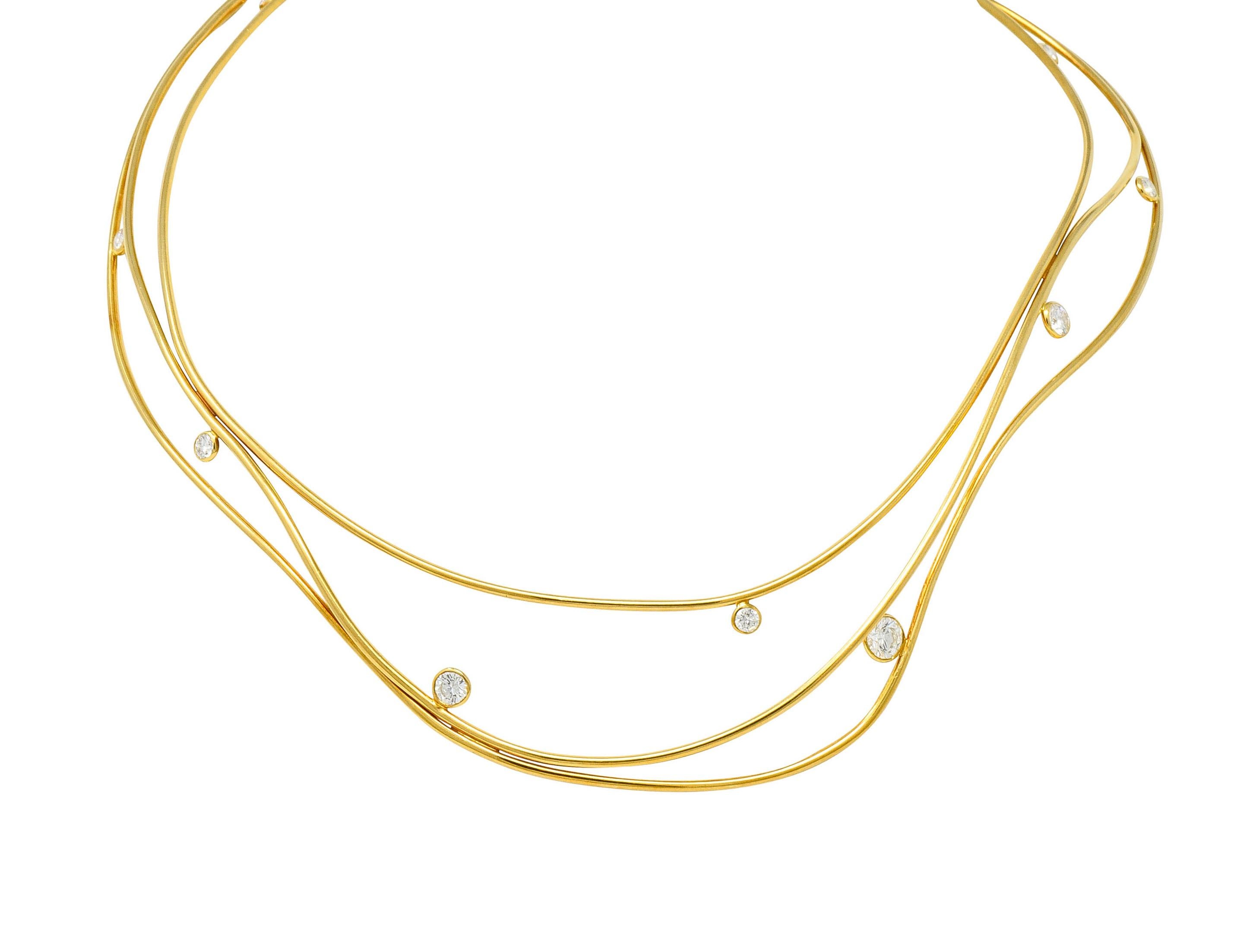Designed as three gold segments organically free-formed into a collar necklace

Accented throughout by bezel set round brilliant cut diamonds, varied in size

Weighing in total approximately 1.08 carats with F/G color and VVS clarity

Completed by a