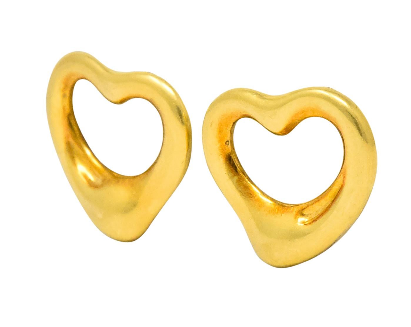 Featuring Elsa Peretti's open heart design in highly polished 18 karat gold

Outline of heart in graduating width and thickness

Fully signed Tiffany & Co. 750 (for 18 karat) Spain and Elsa Peretti makers mark

Post and friction backs

Measures: