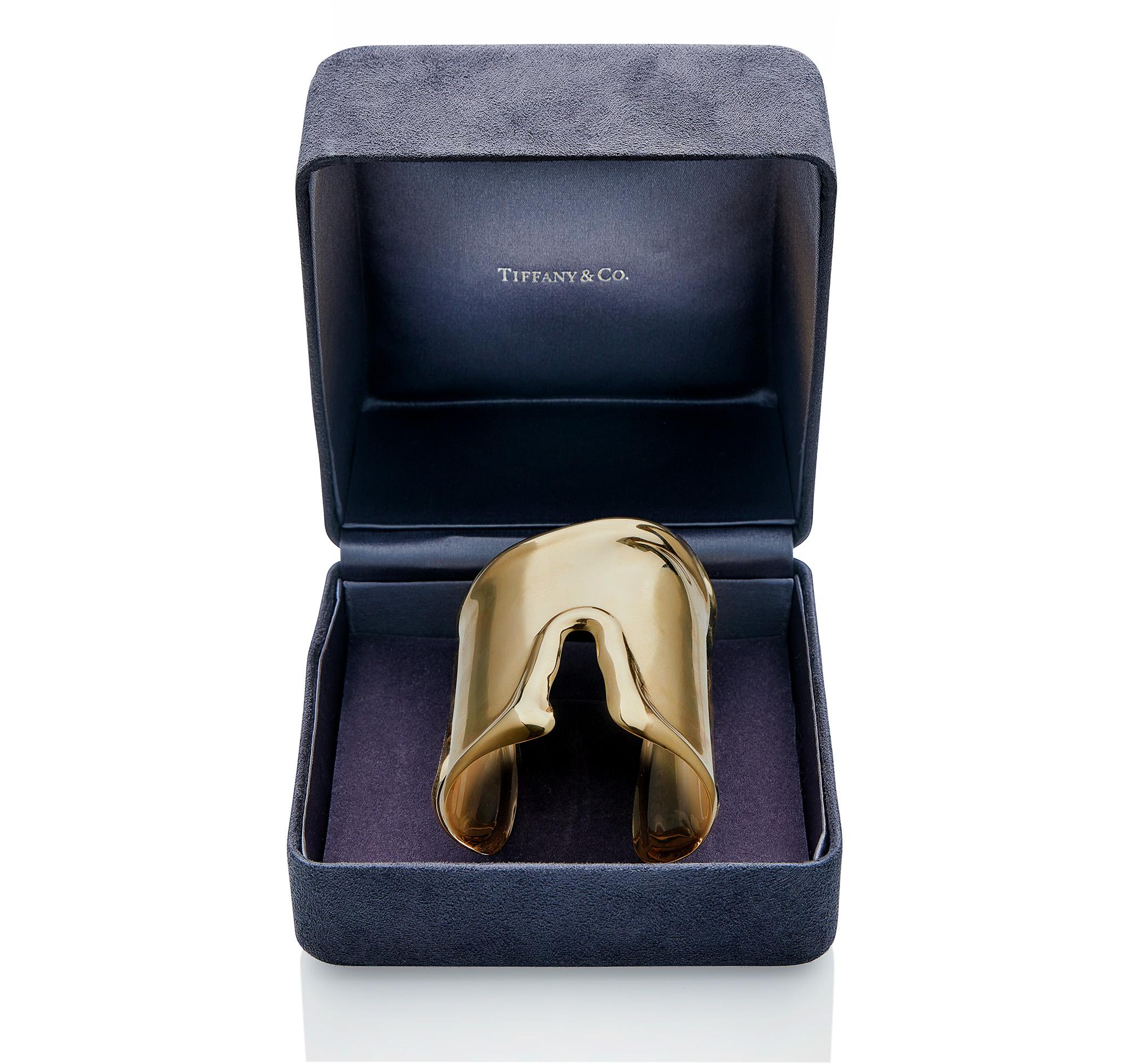 This Elsa Peretti for Tiffany & Co. large bone cuff bracelet, the large design of longer form, is composed of 18K gold. Anatomical in style, with raised edges, the cuff reflects the natural contours of the underlying wrist bone. A contemporary