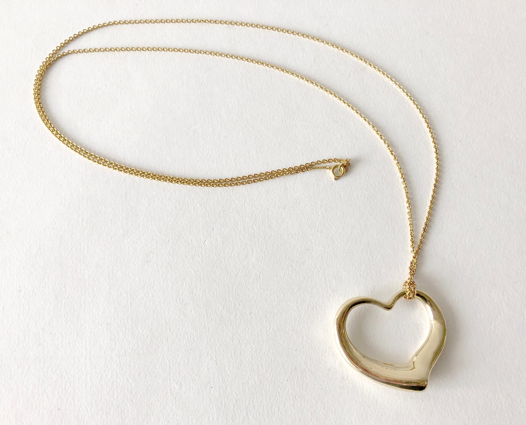 Vintage 18K gold open heart pendant and chain necklace designed by Elsa Peretti for Tiffany & Co.  This is the large version of this design.  It measures 1.25