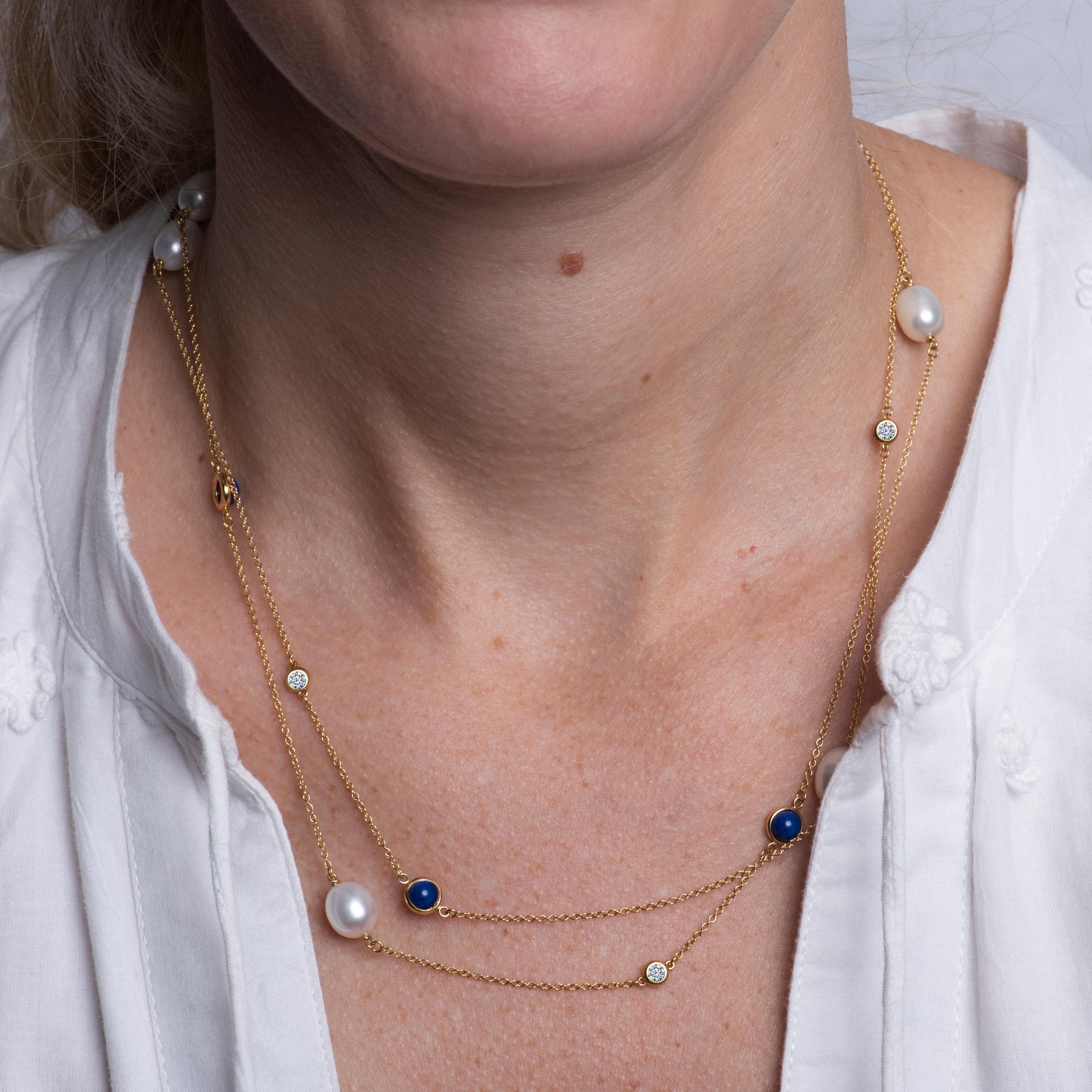 This 18 karat yellow gold Tiffany & Co. necklace designed by Elsa Peretti features 5 oval shaped shimmering pearls alternating with 4 round bezel set lapis and 4 bezel set round diamonds. Spring clasp closure. The necklace is approximately 36.5