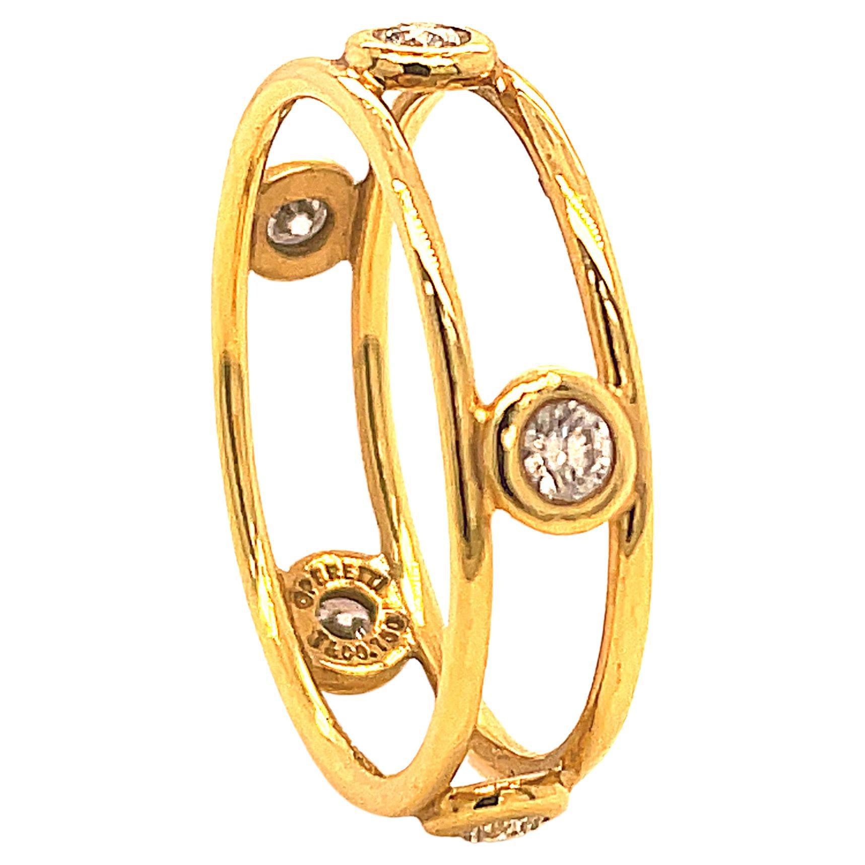 Lovely sparkling band:  two slim bands set with five open-work bezel-set brilliant diamonds.  Made and signed by ELSA PERETTI for TIFFANY & CO.  18K yellow gold.  Size 8 and can be somewhat custom sized.  Bright and wearable.

Alice Kwartler has