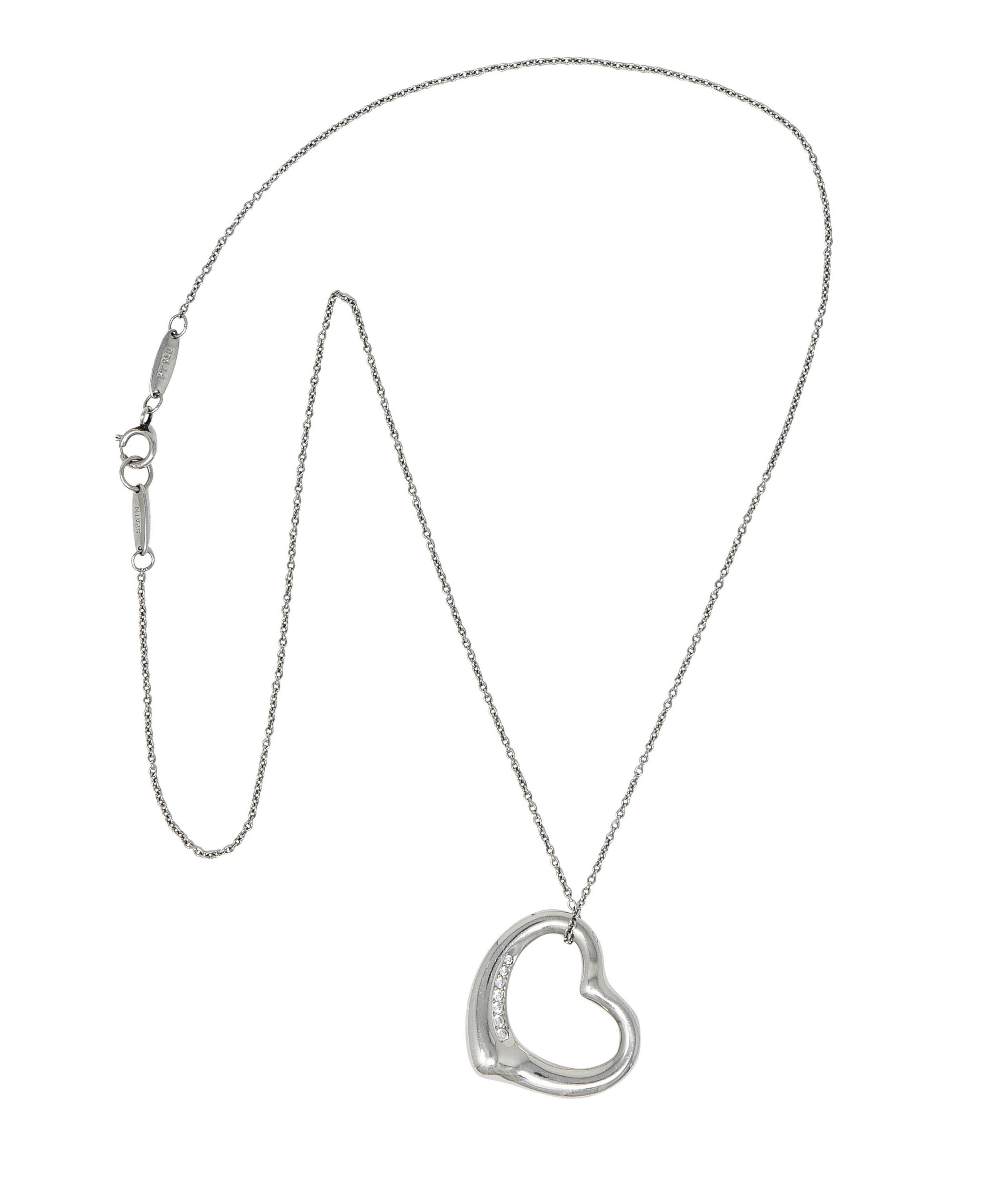 Pendant is designed as the iconic open heart motif

Accented by a bead set round brilliant cut diamonds weighing in total approximately 0.12 carat - eye clean and white

Suspending from a classic cable chain necklace - completed by a spring ring