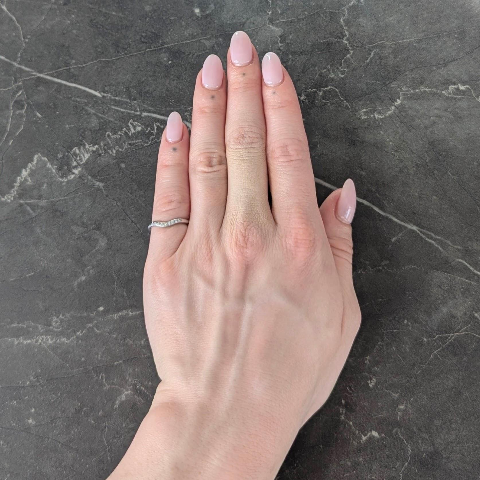 Designed as a contour style band with central curve
With round brilliant cut diamonds flush set to front
Weighing 0.09 carat total - G/H color with VS2 clarity
Completed by high polish finish
Inscribed '99-1-23 Y to M'
Stamped for platinum
Fully
