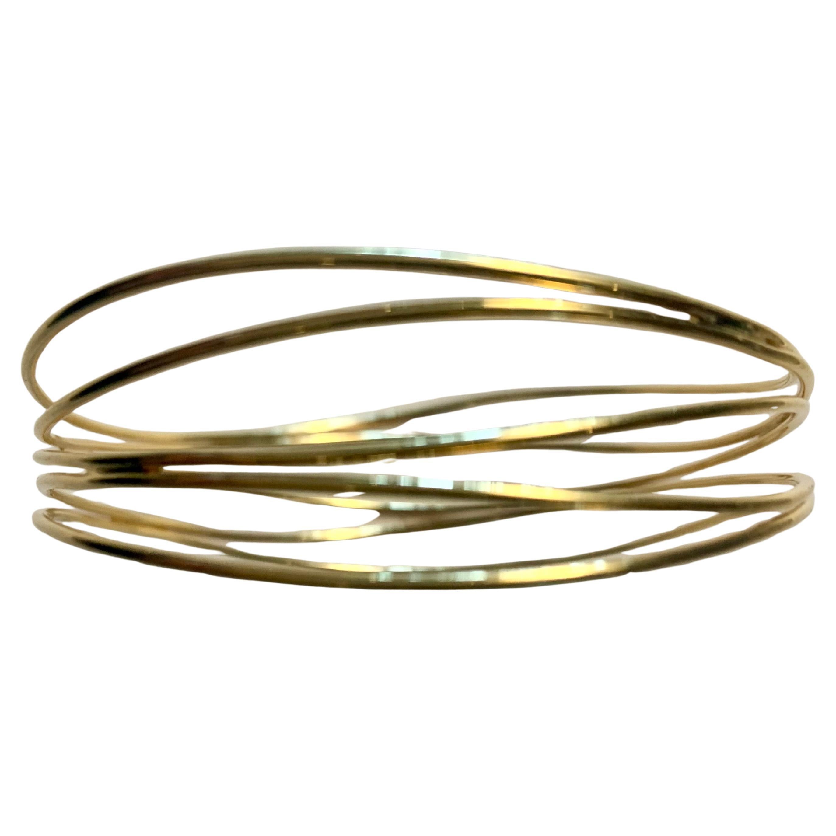 Elsa Peretti designed this fluid Wave bracelet for Tiffany & Co using 18 karat gold and a design that brings to mind ocean waves at the start of her partnership with Tiffany in 1974. Elsa Peretti is known for her love of nature, which she