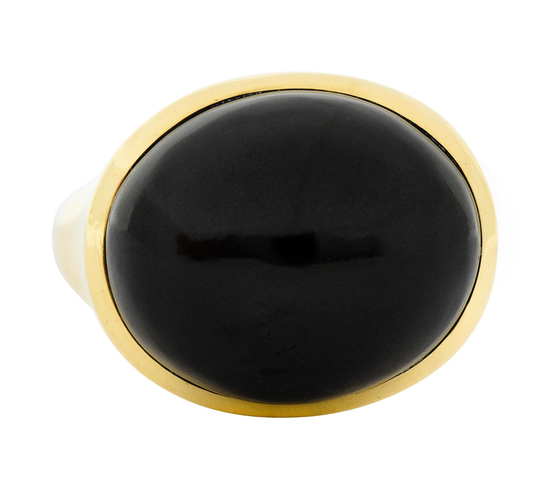 Centering an oval cut onyx cabochon measuring approximately 20.0 x 16.5 mm

Uniformly an opaque black with a very good polish

Bezel set in an undulating polished gold surround

Stamped 750 for 18 karat gold

Fully signed Elsa Peretti Tiffany & Co.