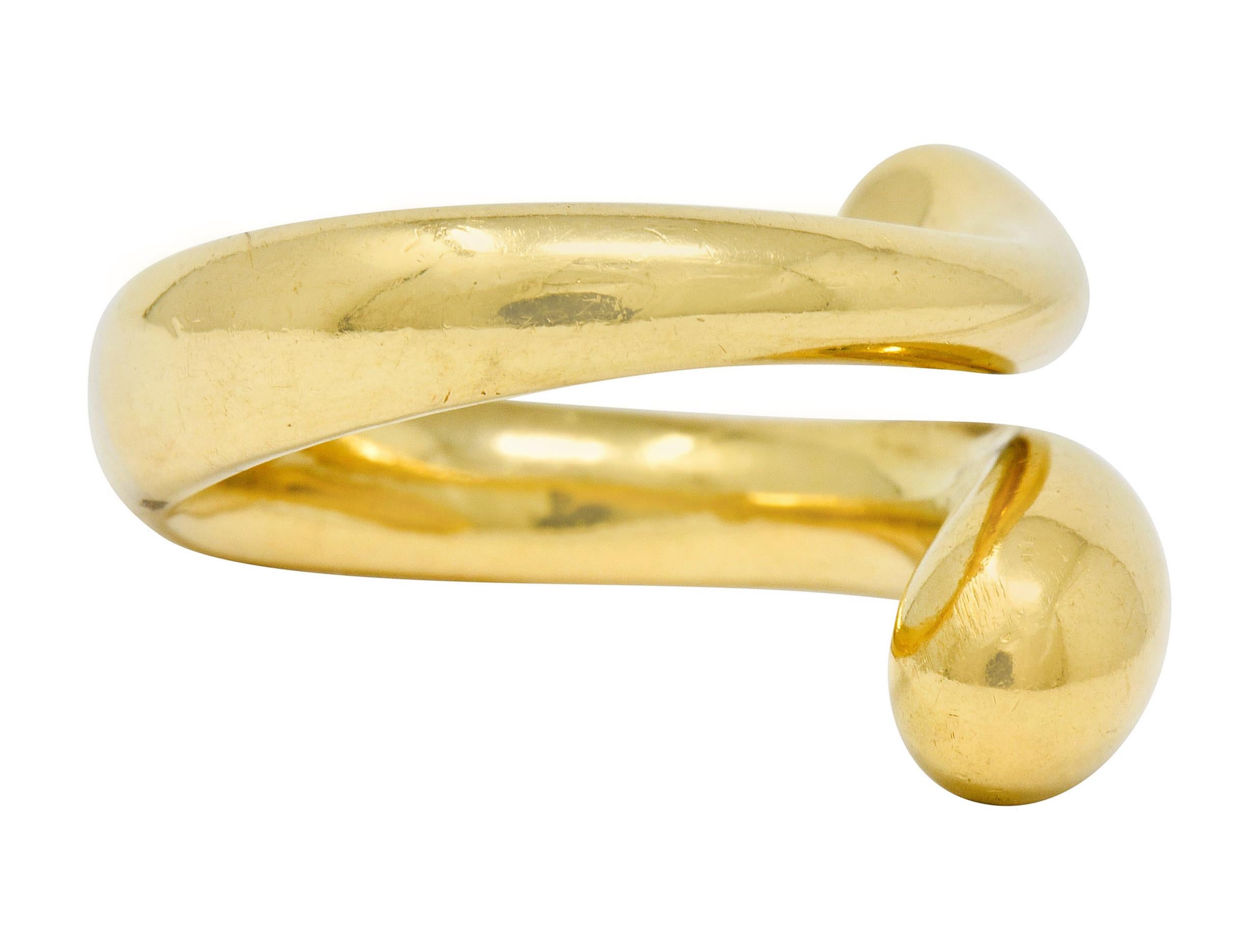 Bypass style ring terminating as two swollen drop-like ends

Organically wraps around finger with a bright finish

Fully signed Tiffany & Co. Elsa Peretti Spain

Stamped 750 for 18 karat gold

From the Teardrop collection, circa 1990s

Ring Size: 6