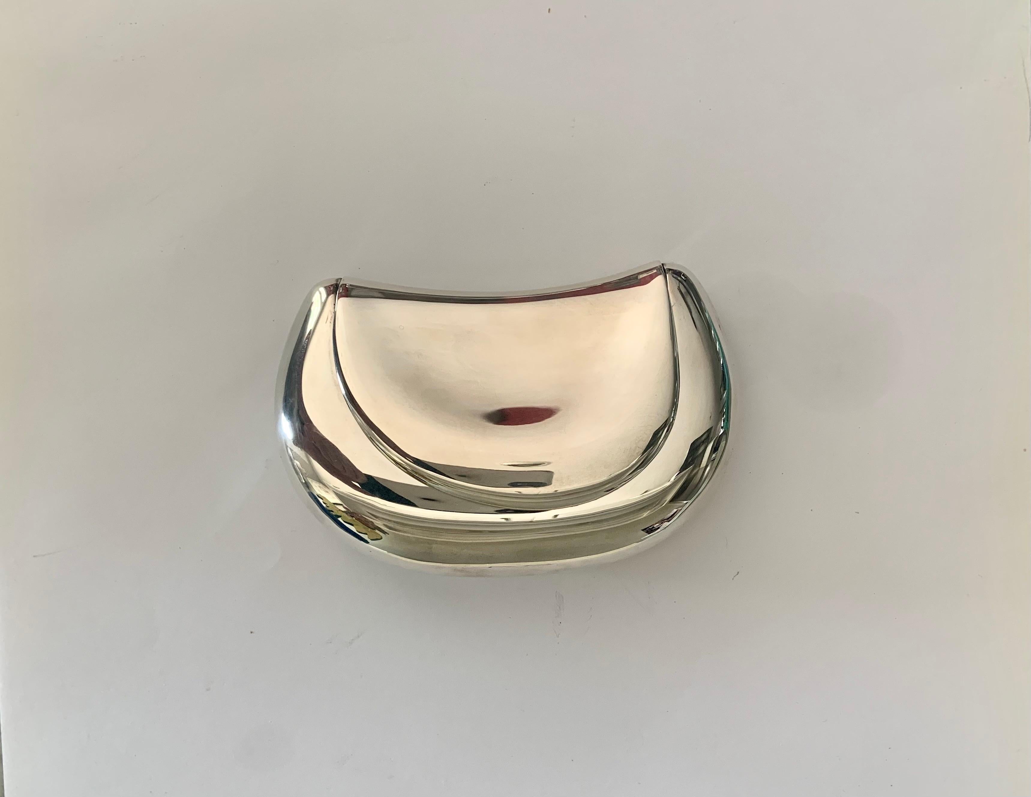 An early design from Elsa Peretti for Tiffany & Co, this stunning and rare sterling silver clutch is so organic, it fits perfectly in the palm of your hand.  The bag is smooth and sleek and just large enough for a lipstick, key and credit card.  It