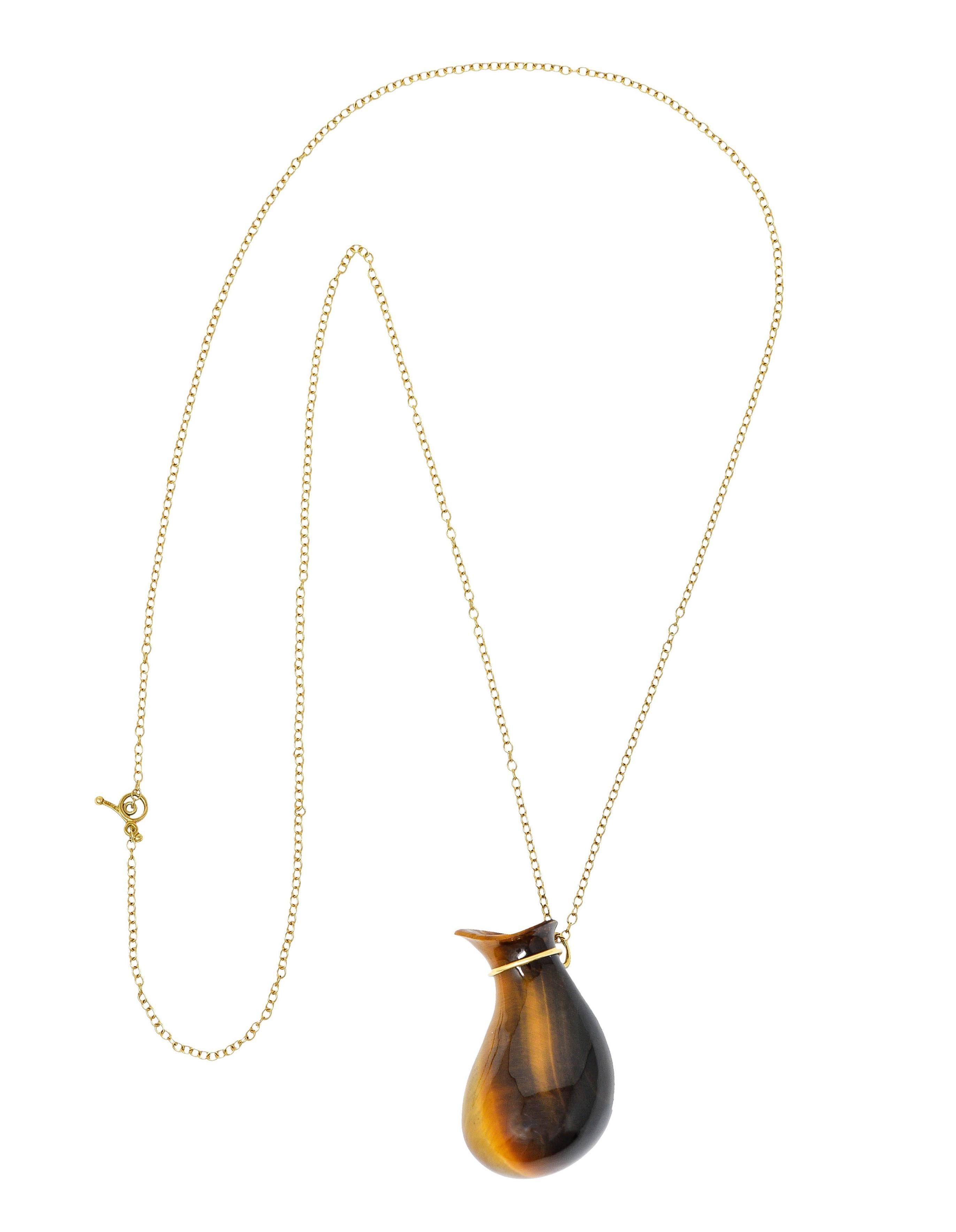 Featuring the iconic bottle jug pendant - fantastically carved from tiger's eye quartz

Opaque with brown to yellowish orange banded color while exhibiting very strong chatoyancy

Suspending from a classic cable chain necklace completed by a toggle