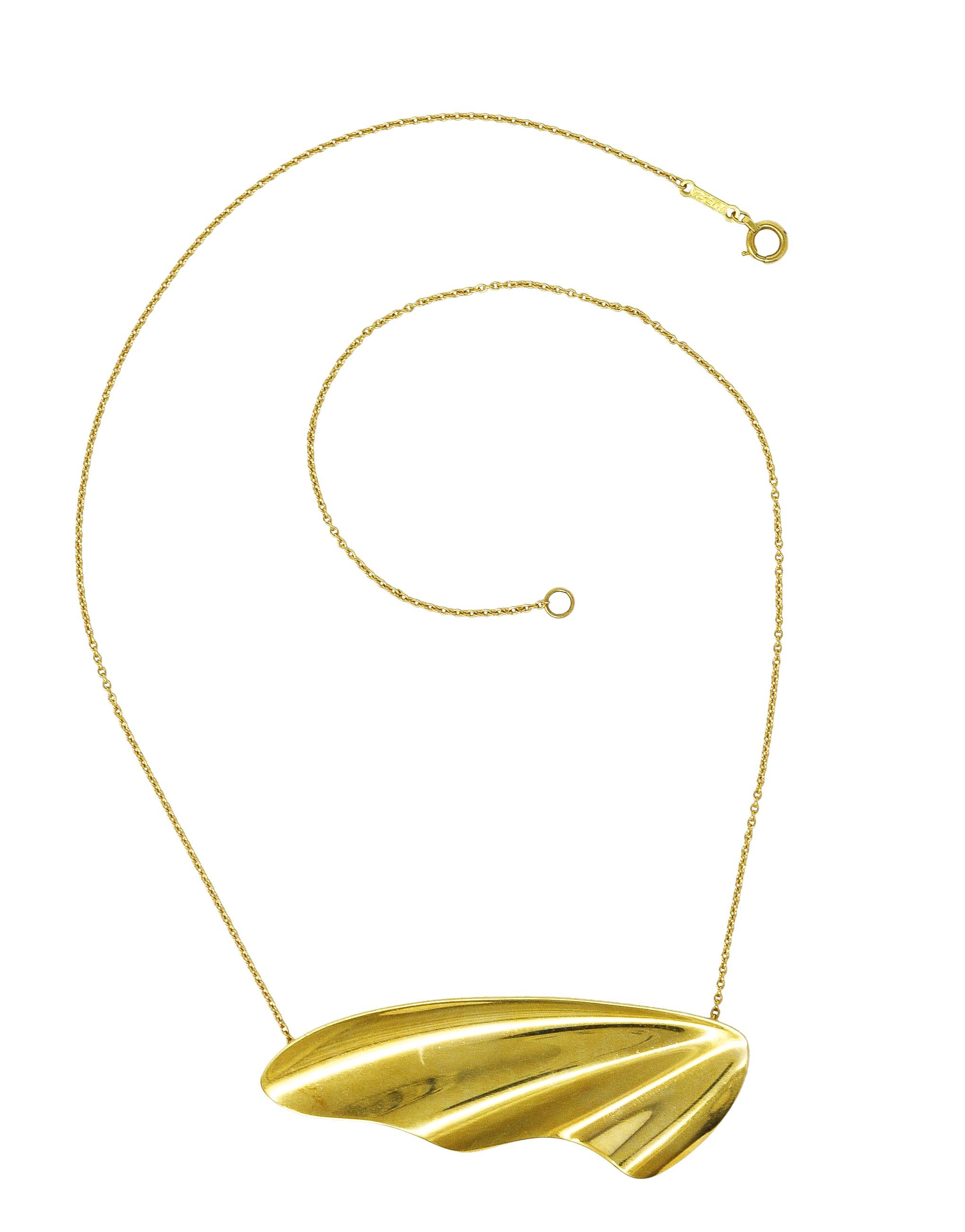 Necklace is designed as cable chain suspending an organically shaped wavy gold form

With high polished gold finish

Completed by spring clasp closure

Stamped 18K for 18 karat gold

Signed for Elsa Peretti Tiffany & Co. Spain

Circa: Late 20th