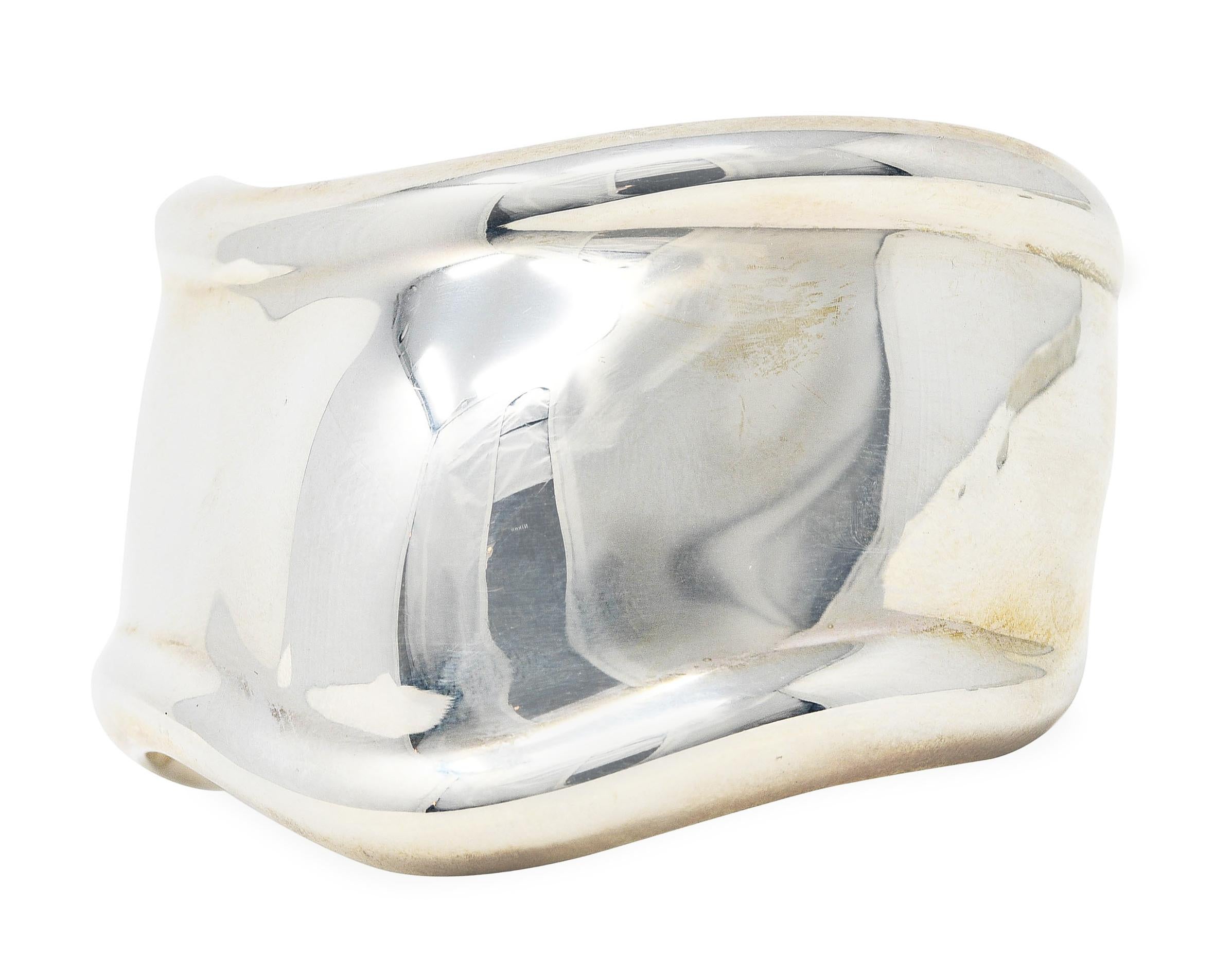 Cuff bracelet is designed as a flowing organic wrist contour

Featuring raised wrist bone motif and fluted edges

With high polished finish

Stamped AG 925 for sterling silver

Fully signed Elsa Peretti Tiffany & Co. Italy

Circa: Late 20th century