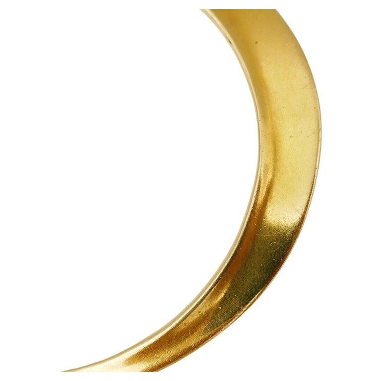 A rare Flying Saucer bangle by Elsa Peretti for Tiffany & Co. Elliptic minimalistic shape makes it wearable with any style. Made of 18k gold (stamped). Signed by Elsa Peretti and Tiffany & Co.
Measures: inner circumference is 7.5