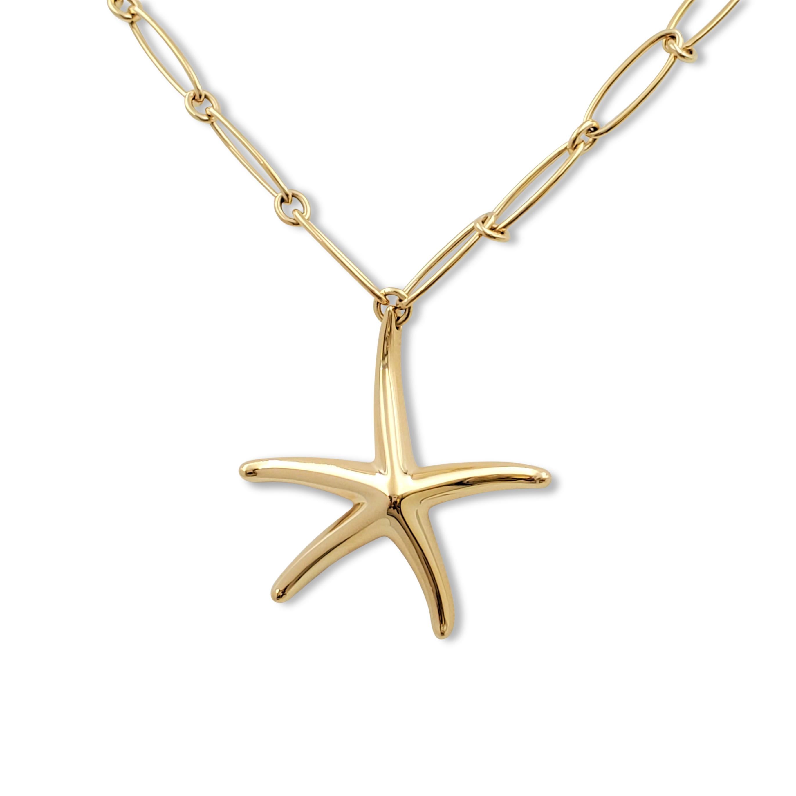 Authentic Elsa Peretti for Tiffany & Co. starfish pendant crafted in 18 karat yellow gold hangs from a link-style chain comprised of elongated oval links alternating with round jump ring spacer links. Signed Tiffany & Co., 750, Elsa Peretti. The