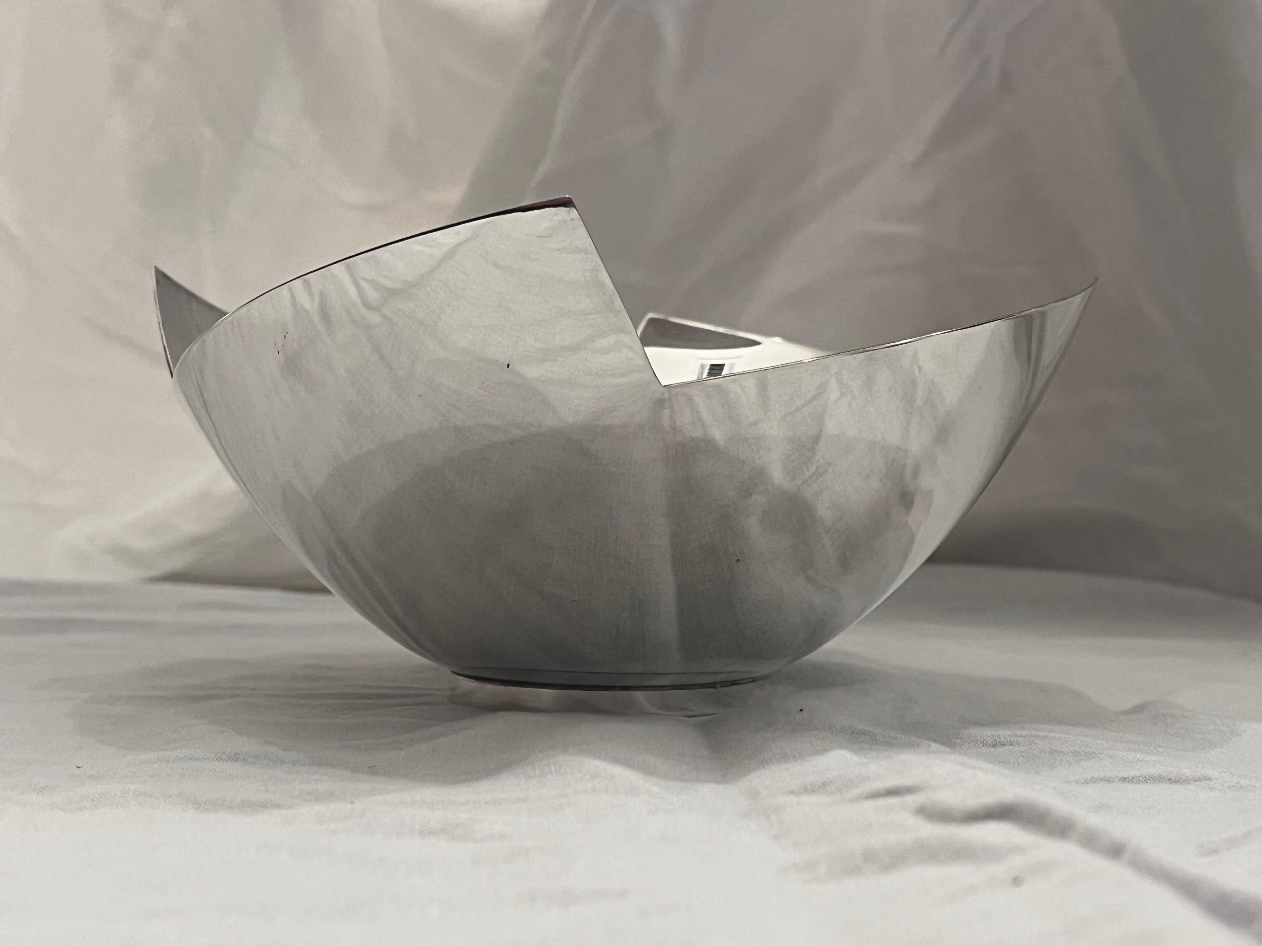 A beautiful and striking post modern style silver plate bowl by Elsa Rady for Swid Powell circa 1990's. The strong geometric lines of the lip are softened by the gentle curve of the bowl itself and the wonderful proportion and scale that the piece