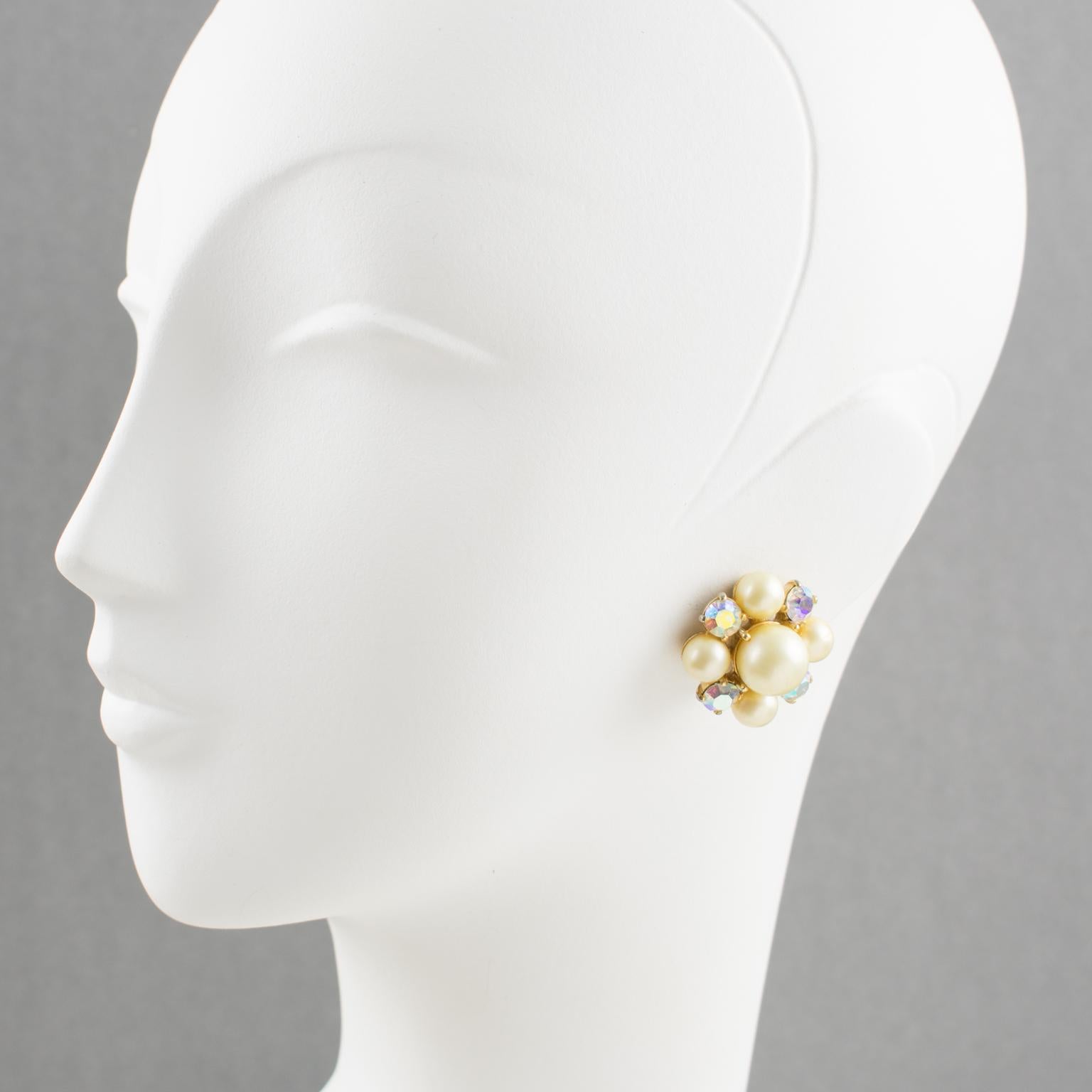 Lovely 1960s clip-on earrings by Elsa Schiaparelli (1890 - 1973). Featuring a geometric floral design with gilt metal framing topped with pearl-like and aurora borealis crystal rhinestones. Marked underside 