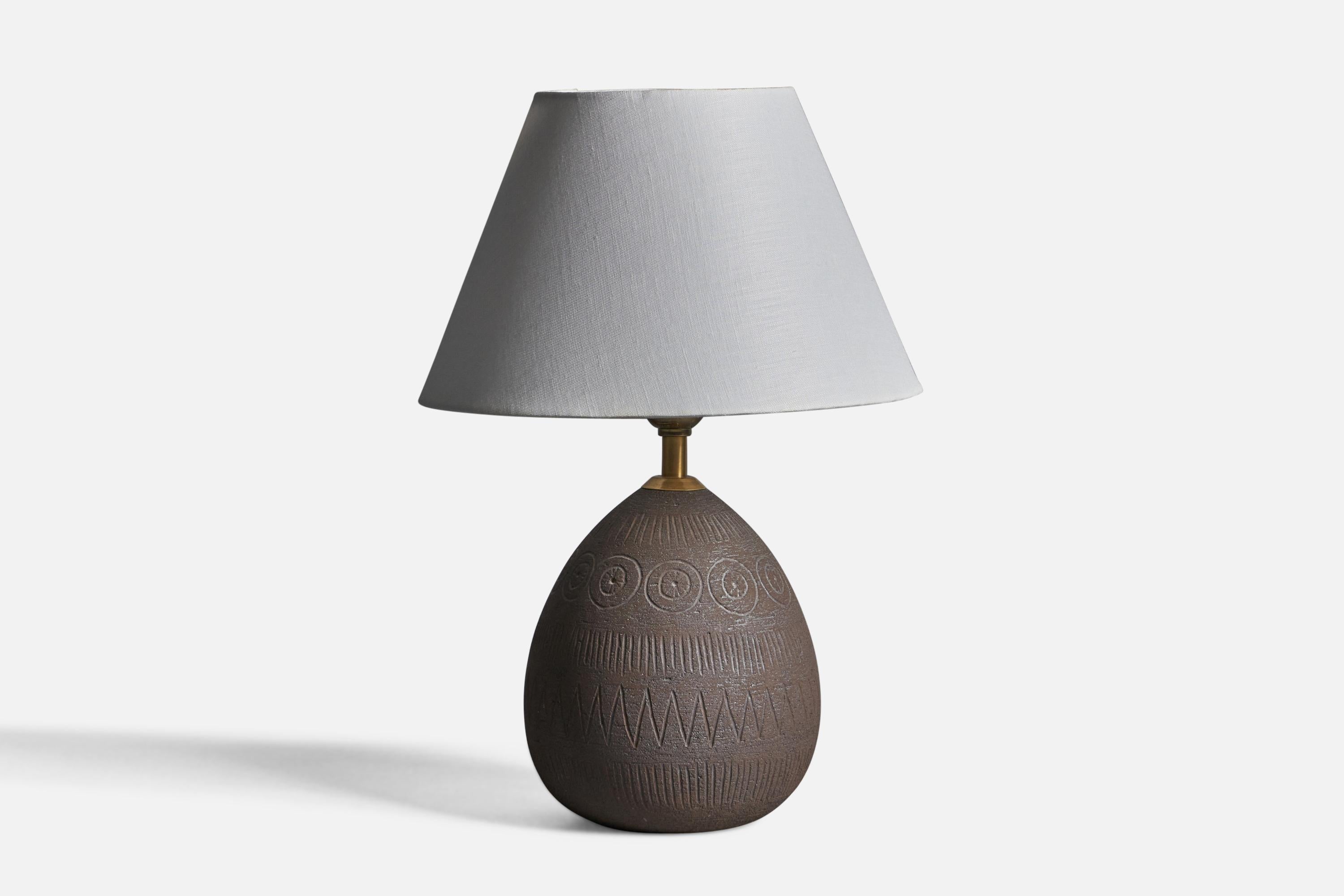 An unglazed incised stoneware and brass table lamp designed and produced by Elsi Bourelius, Sweden, c. 1960s.

Dimensions of Lamp (inches): 10.5