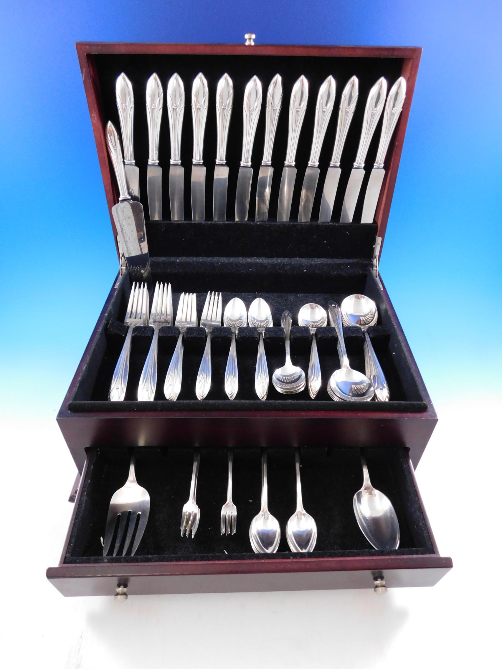 Art Deco dinner size Elsinore by International sterling silver flatware set, 99 pieces. Alfred G. Kintz designed the Elsinore pattern, first introduced in 1931, which features a flared handle with tapered tip, scalloped detailing, and beaded