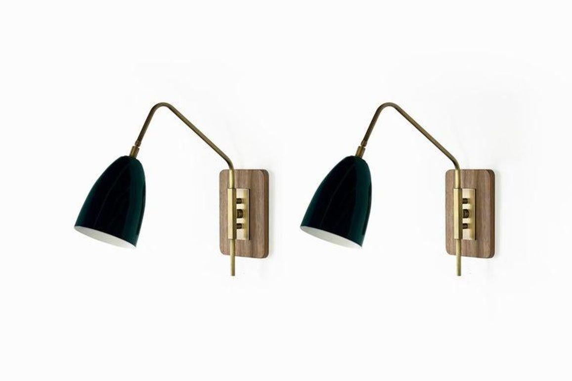 The Elska Wall Mount Reading Lamp is a stylish and functional fixture that draws inspiration from Scandinavian, Danish, and Italian Mid-Century Modernism. Its walnut backplate and architectural brass fittings create a visually stunning design