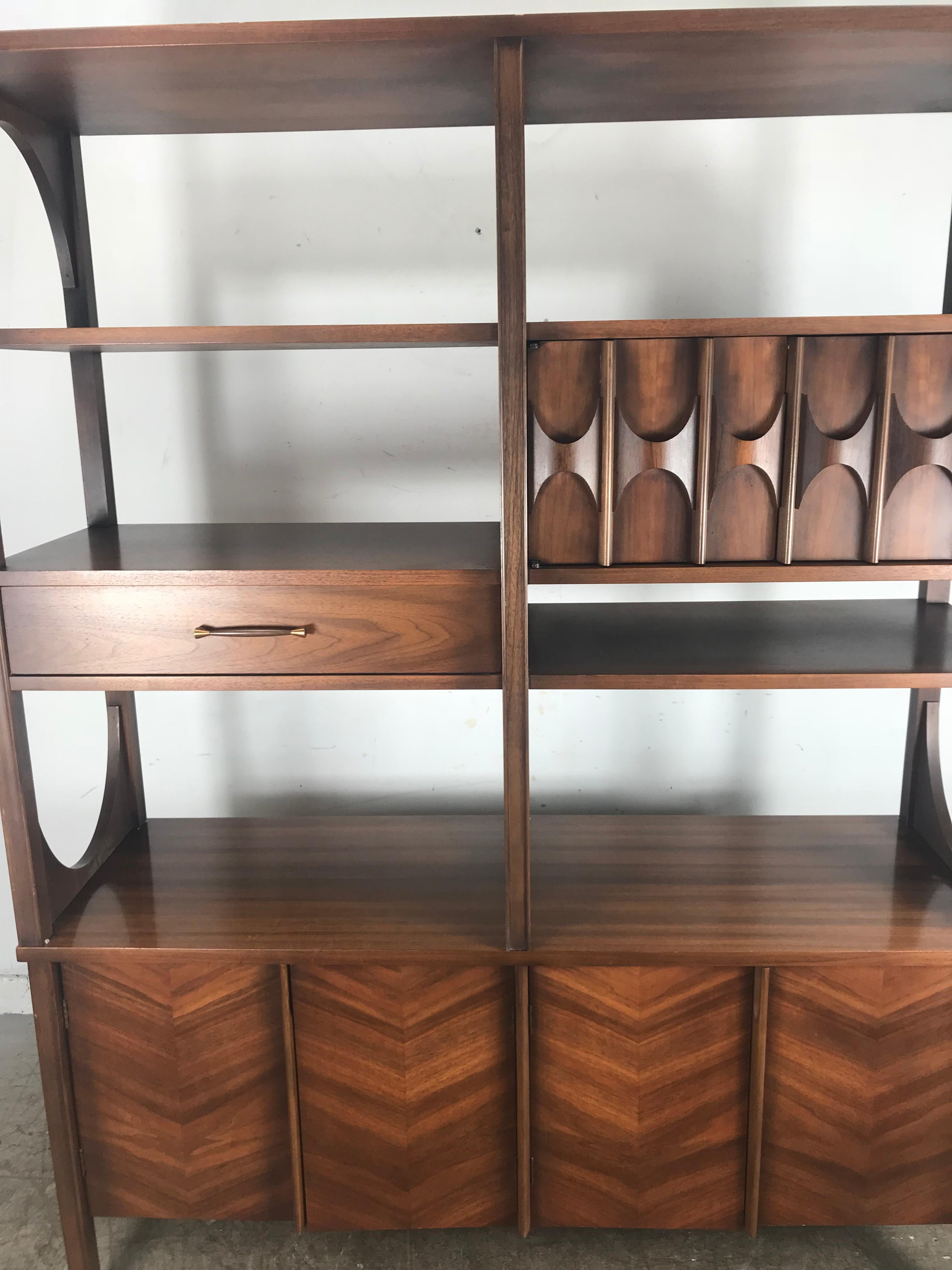 Elusive Kent Coffey Perspecta double-sided room divider. Amazing sculpted walnut finished on both sides. Wonderful design. Front side featuring one drawer, three cabinets and multi shelving, back side beautiful sculpted panel, and lush
