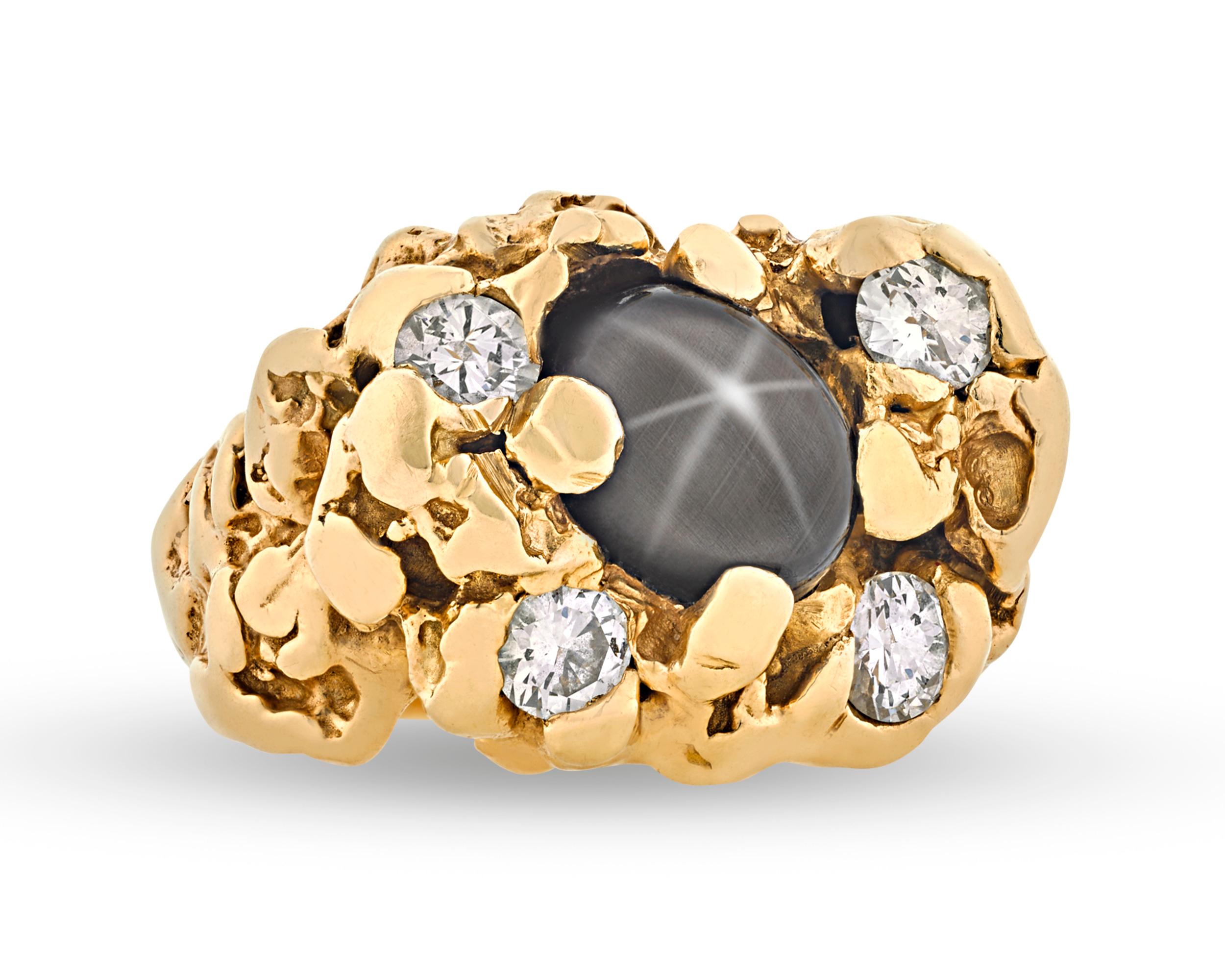This ring was once owned and worn by one of the most celebrated cultural icons of the 20th century, Elvis Presley. Crafted from hammered 14K yellow gold, the impressive ring's highly sculptural form is inset with four white diamond accents. At the