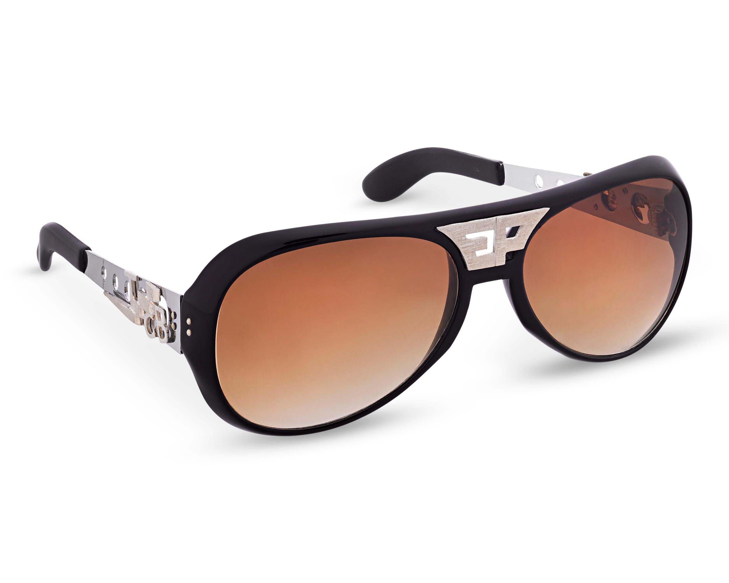 As one of the most celebrated performers of the 20th century, Elvis Presley's image was intertwined with his statement-making fashion choices, most notably his oversized sunglasses and sideburns of the 1970s. This pair of Polaroid aviator sunglasses