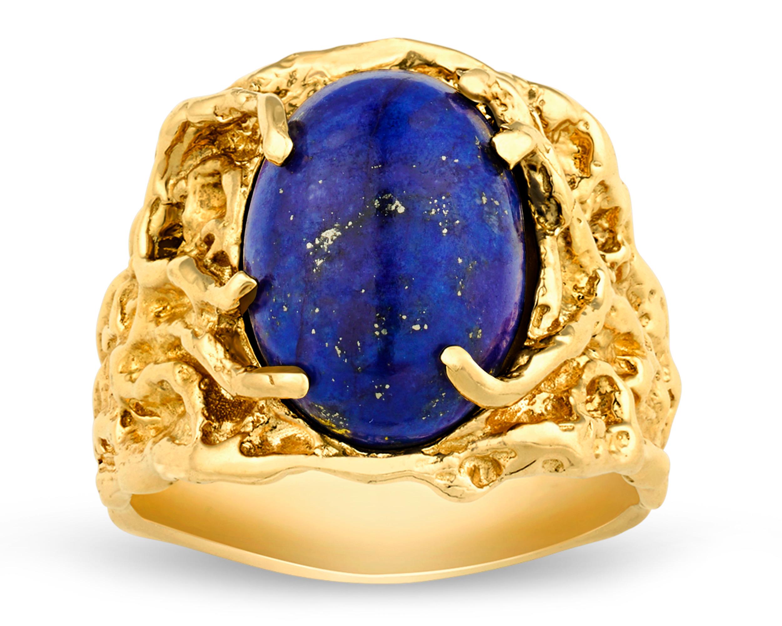 This fascinating ring was owned and worn on stage by perhaps the most celebrated cultural icon of the 20th century, the King himself, Elvis Presley. The jewelry creation features a large, vibrant blue lapis cabochon surrounded by a highly unique 14K
