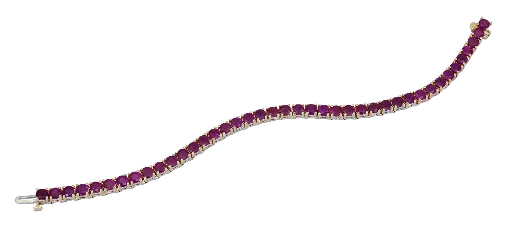 A timeless tennis bracelet style showcasing a row of vibrant rubies, set in a polished 14k yellow gold setting.
Rubies weigh 16 carats total. 
7.13 inches in length.