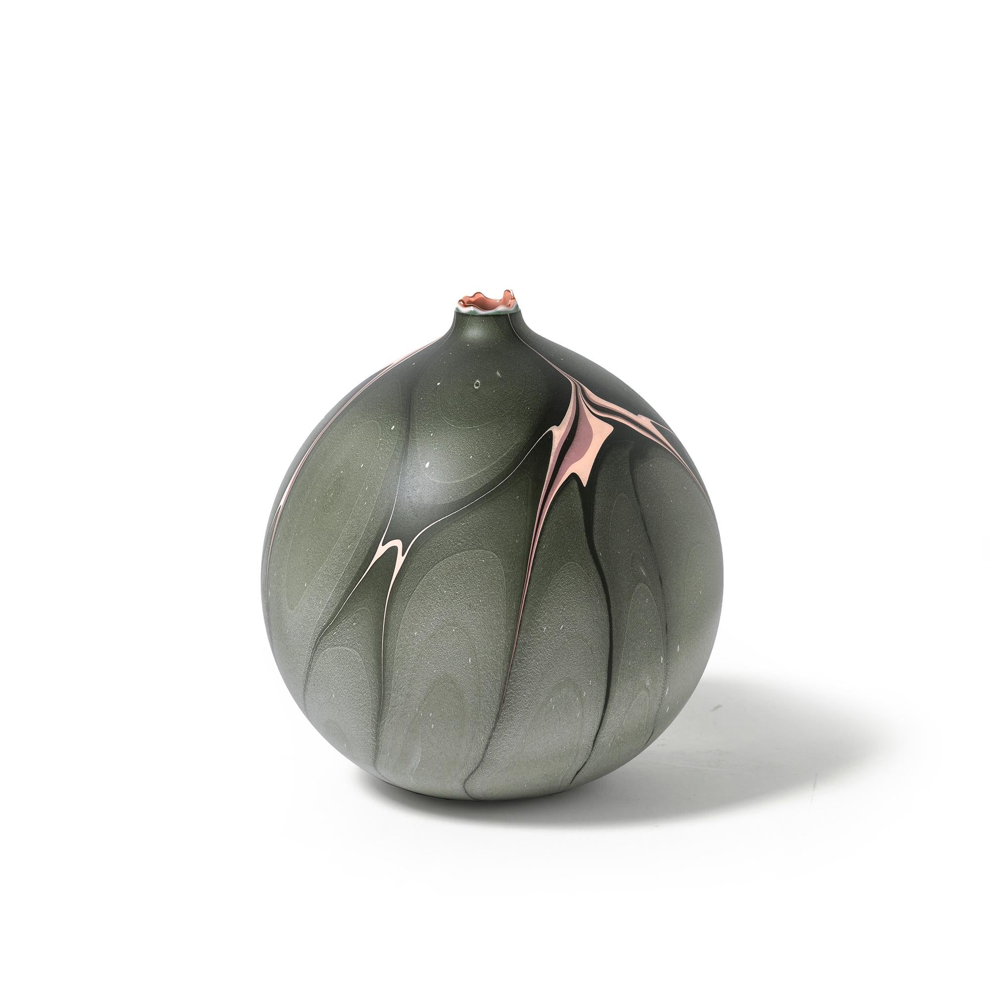 Manifested by Los Angeles based sculptor, Elyse Graham, the Amazon Vase is 9" h x 8"w x 8"d and is part of her Hydro Collection. This vessel features a hand-dyed marbled design of olive green with lavendar and lilac on the surface and a soft pink