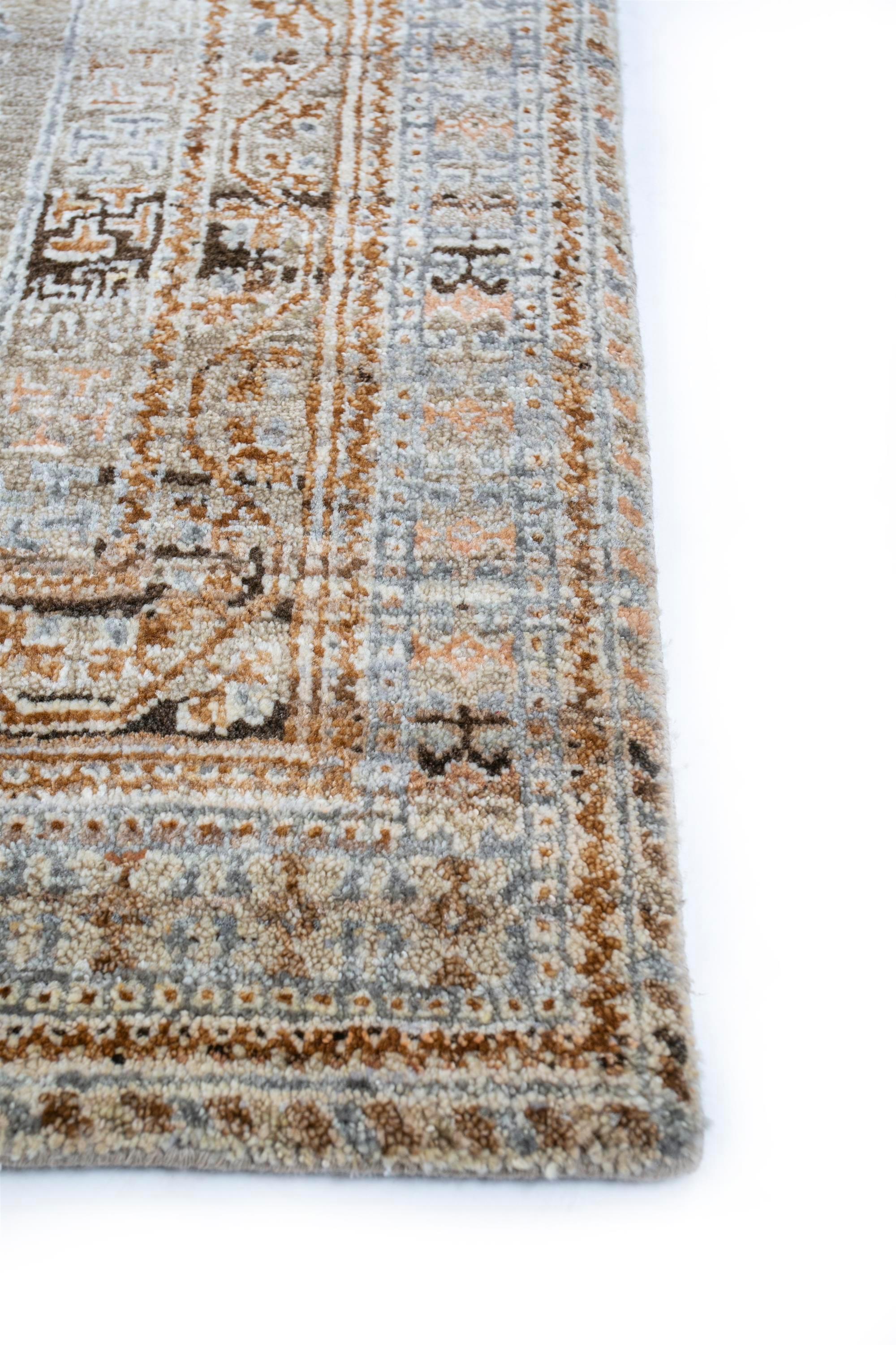 Elevate your living space with our hand-knotted rug, a seamless blend of wool and silk. The earthy tones of clay and cloud white border create an inviting canvas adorned with ornate designs. Immerse yourself in the intricate patterns, transcending