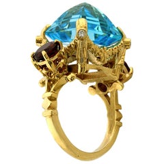 9 Karat Yellow Gold Ring with Blue Topaz, Garnets and Diamonds