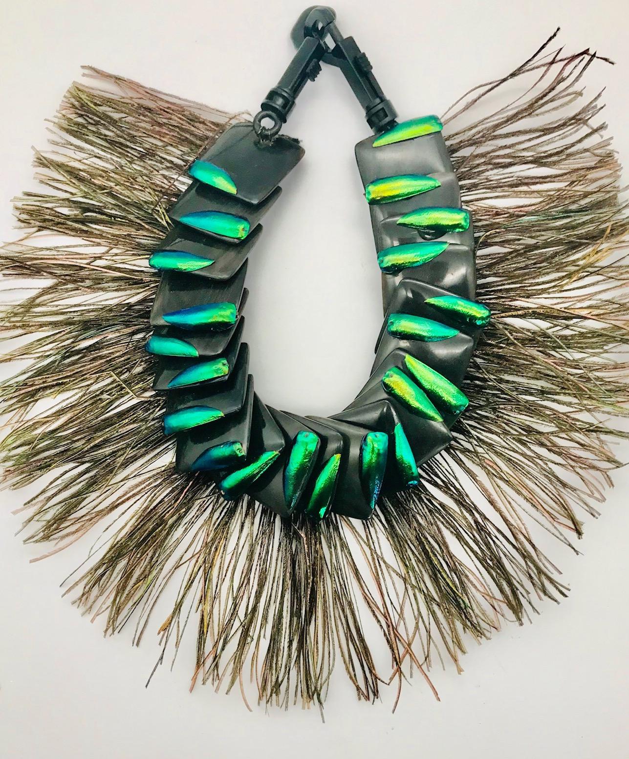 Theatrical ,Statement necklace comprising Elytra Wings on black Resin Squares and Peacock Feathers. This necklace was designed for a theatre in WDC.  Later on it was worn at the Fashion Show in Galle, Sri Lanka, during a Literary and Art Fest, where