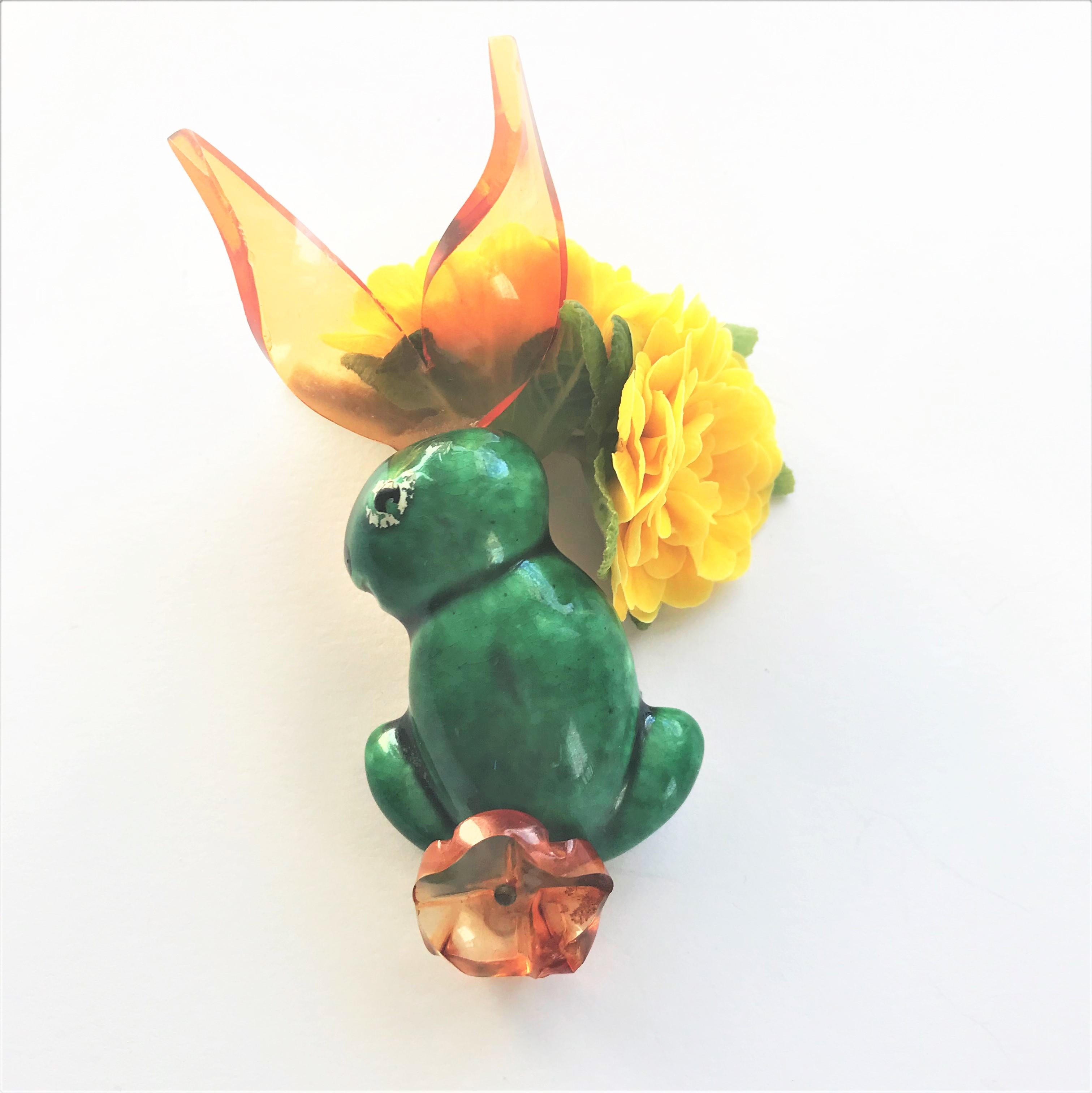 HAPPY EASTER !
hand painted ceramic brooch - yellow lucite, green, black white enamel presents a rabbit with long ears 10 cm x 3  x 1,5 cm thick

Manufacturer Elzac, Inc., Los Angeles, Designer Elliot Handler   shown in 'A ATRIBUT TO AMERCA'  
