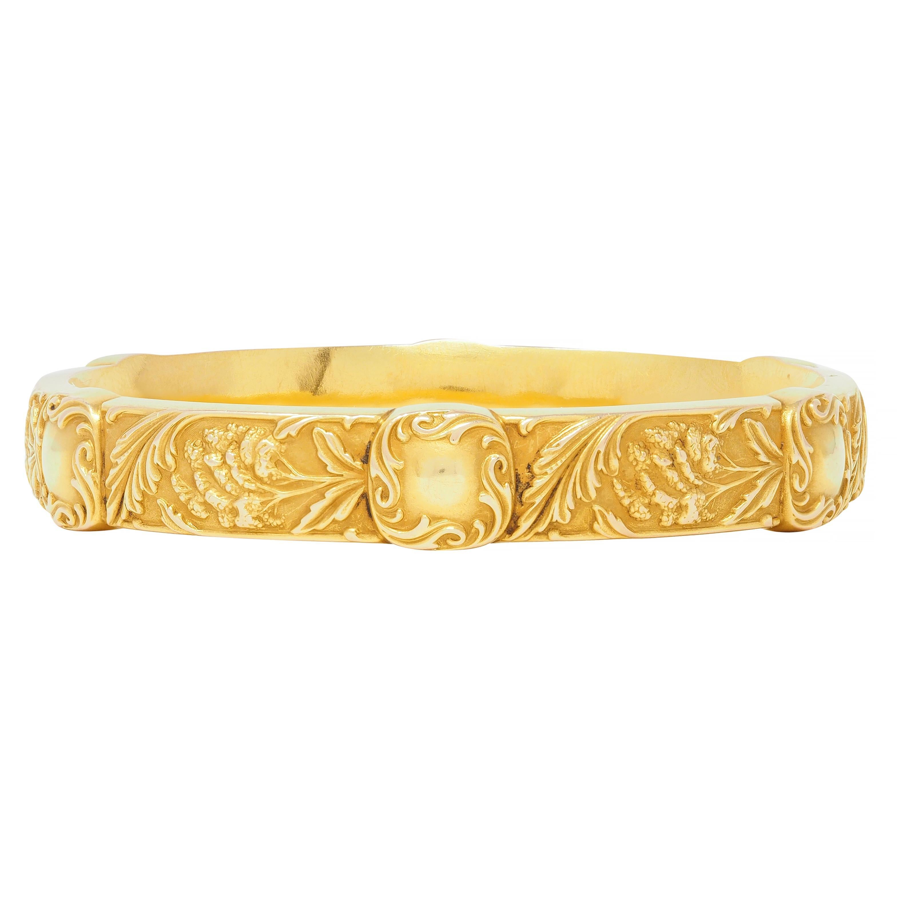 Designed as a curved bangle with raised amaranth flowers rendered throughout
Featuring six cushion-shaped scroll motif stations
Stamped for 14 karat gold
With maker's mark for E.M Gattle
Circa: 1905
Width at widest: 7/16 inches
Bracelet size: 7 1/2