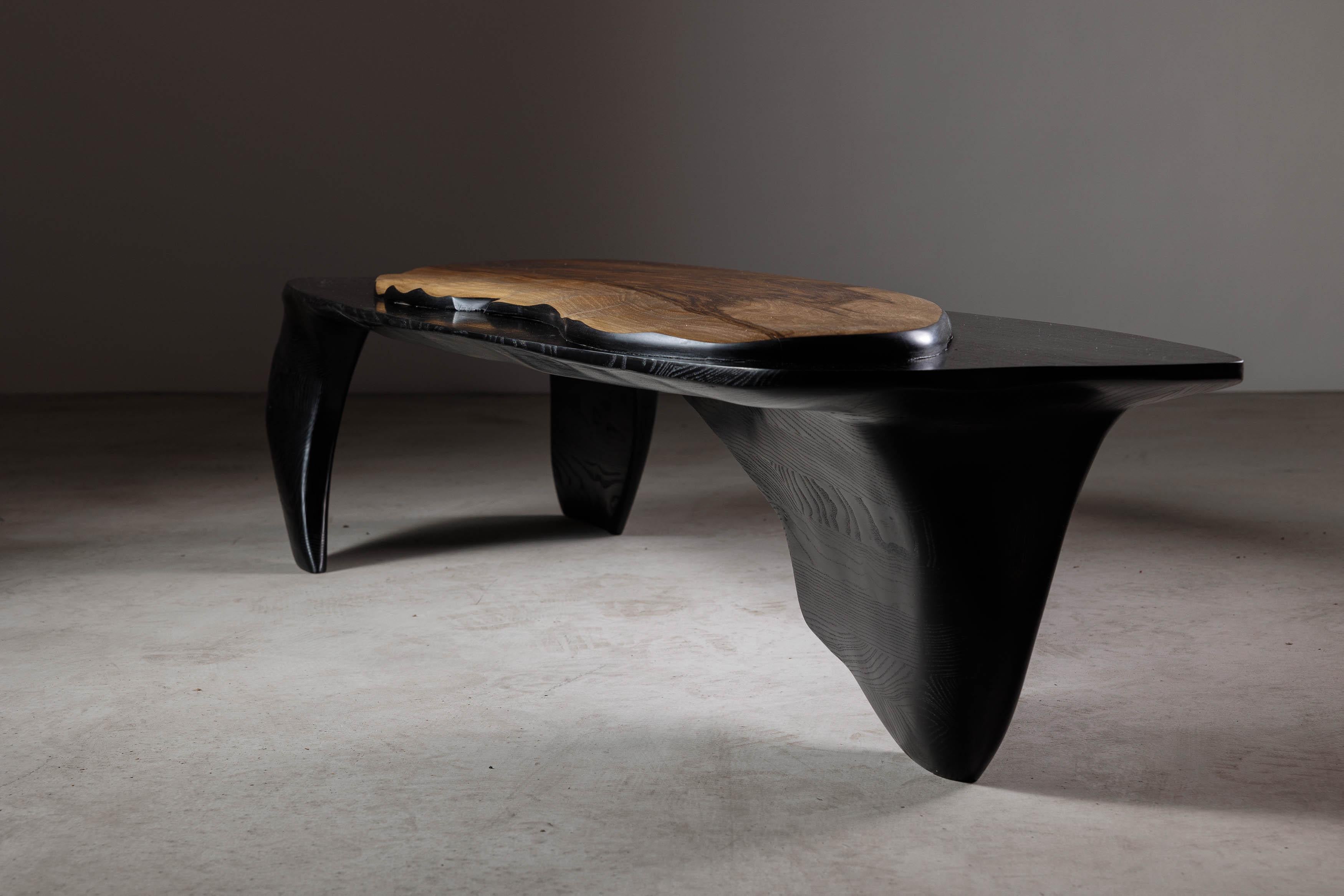 EM110 coffee table by Eero Moss
One of a kind
Dimensions; W 171 x D 49 x H 33 cm
Materials: Walnut, ash, India ink.
Finish: Natural oils.

Erosio Collection

This collection is an ode to the fluid, organic shapes found in the natural world.