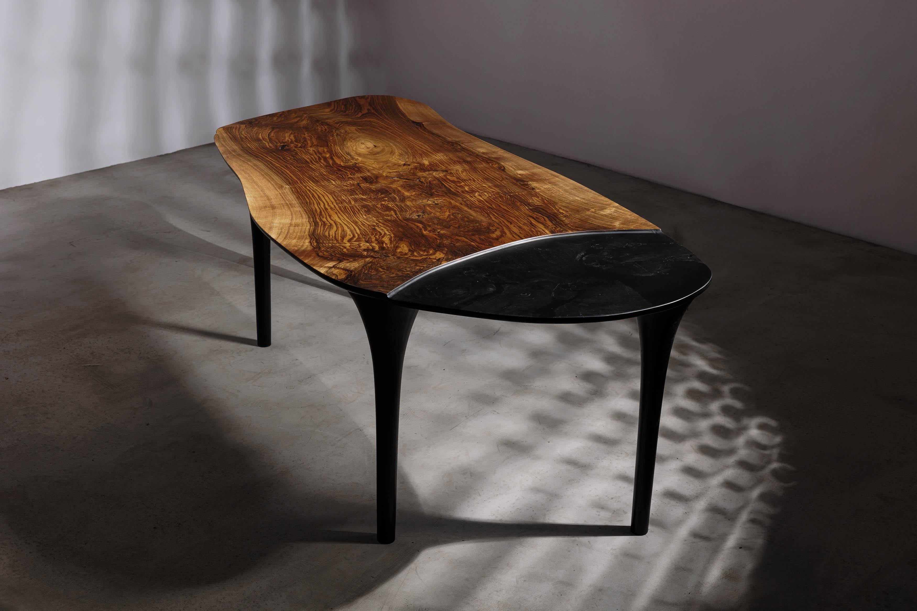 EM210 coffee table by Eero Moss
One of a kind
Dimensions; W 200 x D 96 x H 78 cm
Materials: Walnut, ash, India ink.
Finish: Natural oils.

Erosio Collection

This collection is an ode to the fluid, organic shapes found in the natural world.