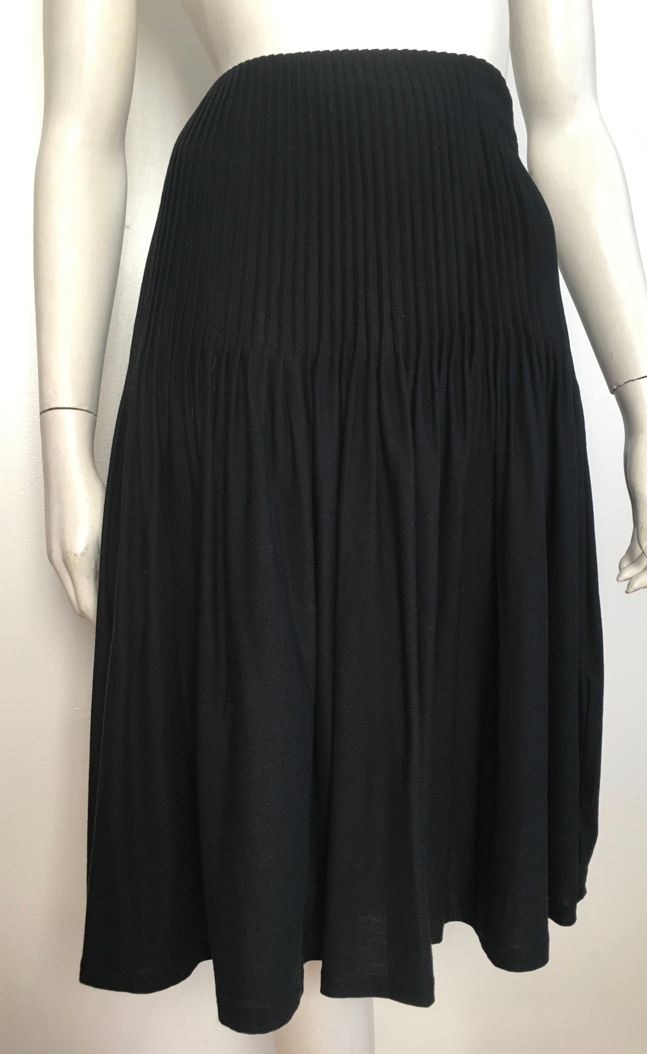 Emanuel Ungaro 1990s silk & cotton jersey black pleated skirt is labeled a size medium and will fit a size 10.  The waist on this skirt is 33