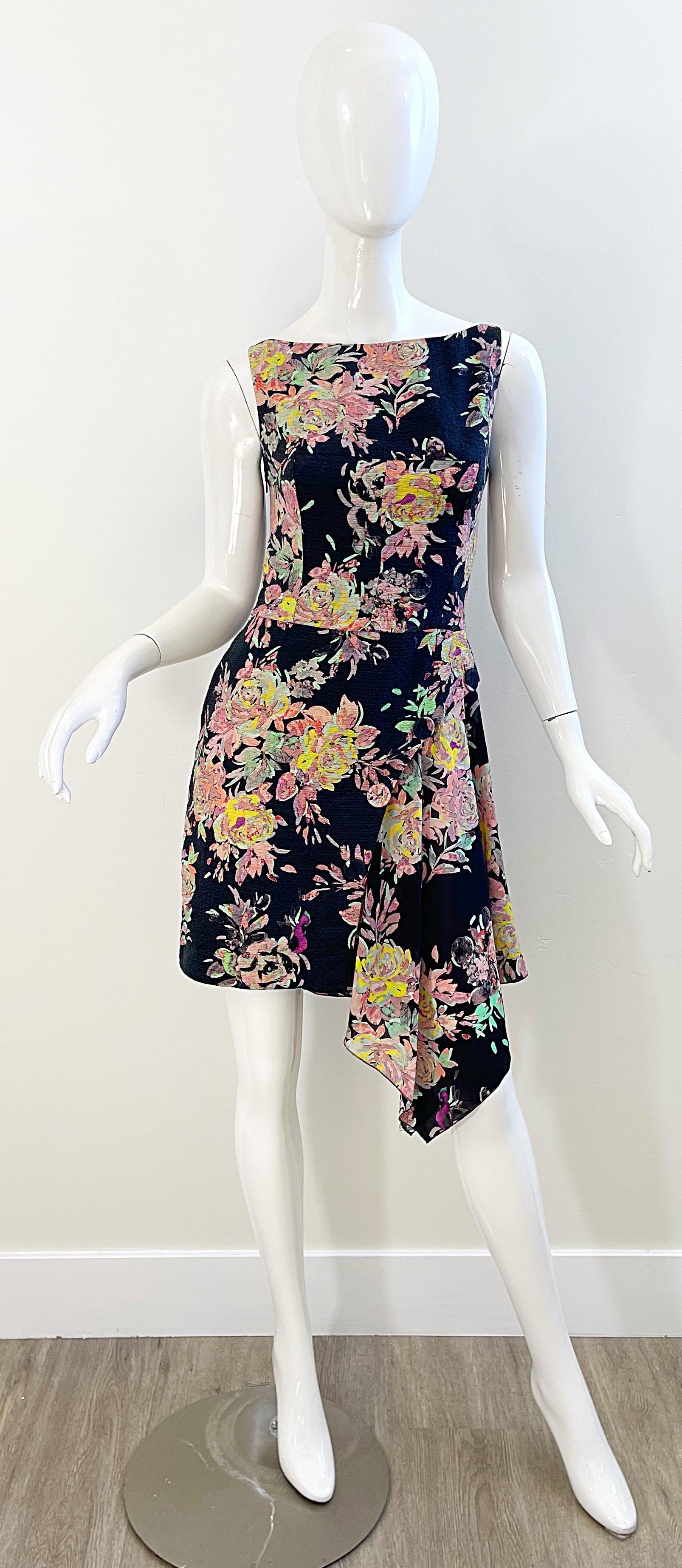 Chic early 2000s EMANUEL UNGARO cotton and silk handkerchief hem dress ! Features a soft cotton bodice with a flowy chiffon side hem. Black base with colorful floral prints in pink, yellow, green, fuchsia, and orange throughout. Hidden zipper up the