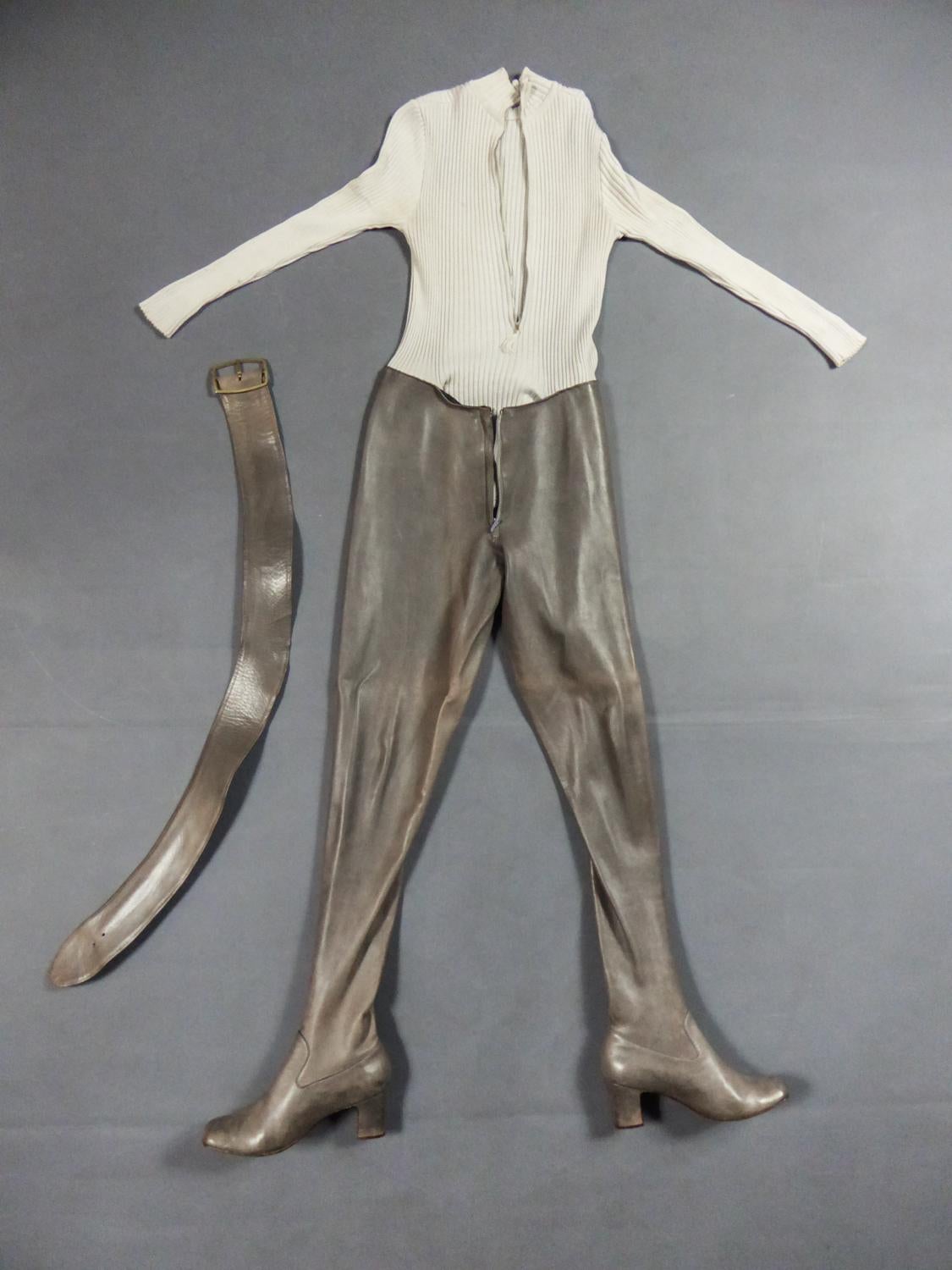 Circa 1970
France

Amazing modern-day Amazon with this full coverall with integrated Leather thigh boots from Emanuel Ungaro Parallèle from the 1970s. Zipped top with small collar and long sleeves in cream stretch knitted cotton. Thigh boots pants