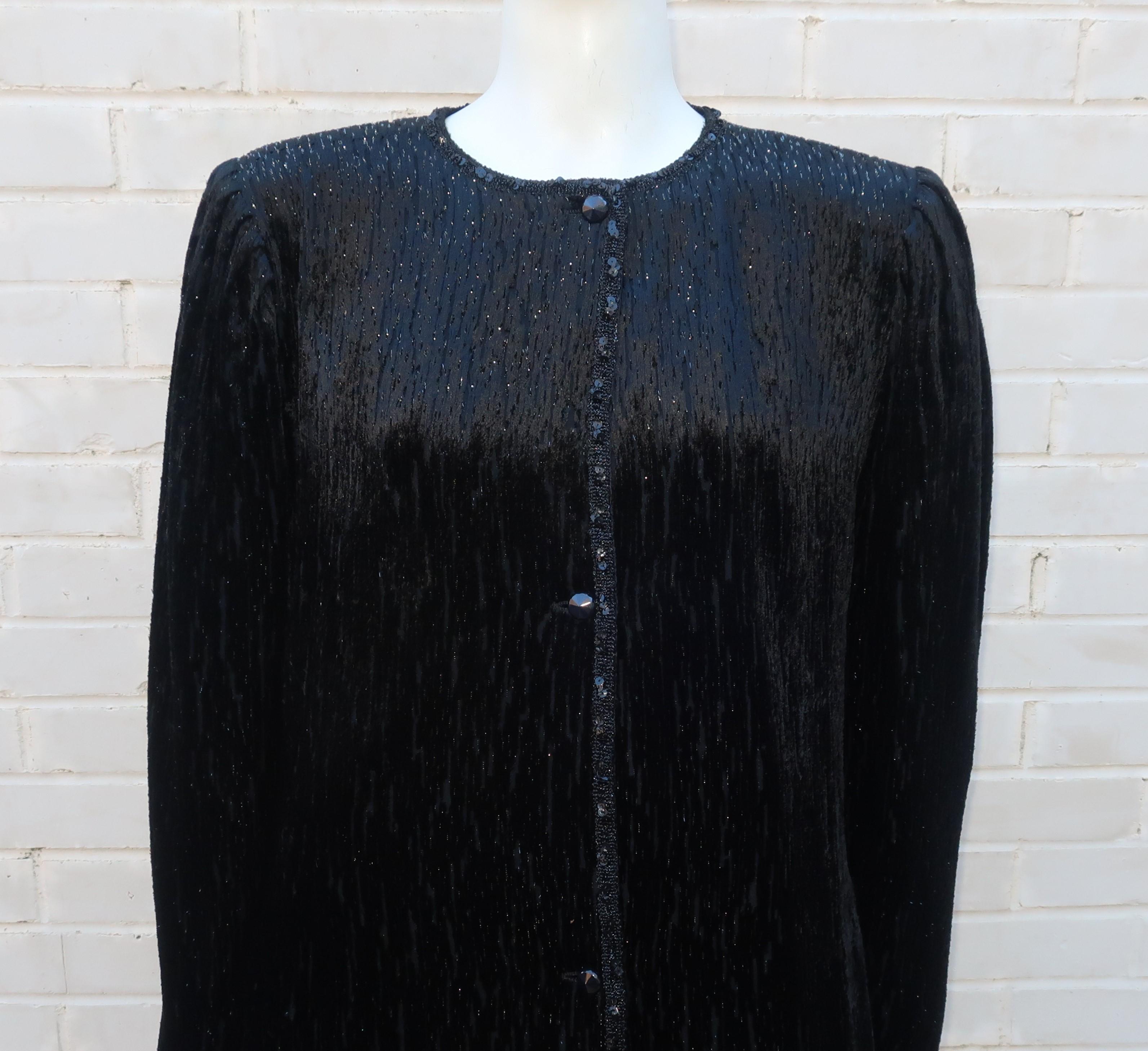 1980's Emanuel Ungaro skirt suit consisting of a skirt and matching coat in a cut velvet fabric accented by metallic threading.  The collarless coat has a modified asymmetrical button front closure, side pockets and a sequin embellished braid trim. 