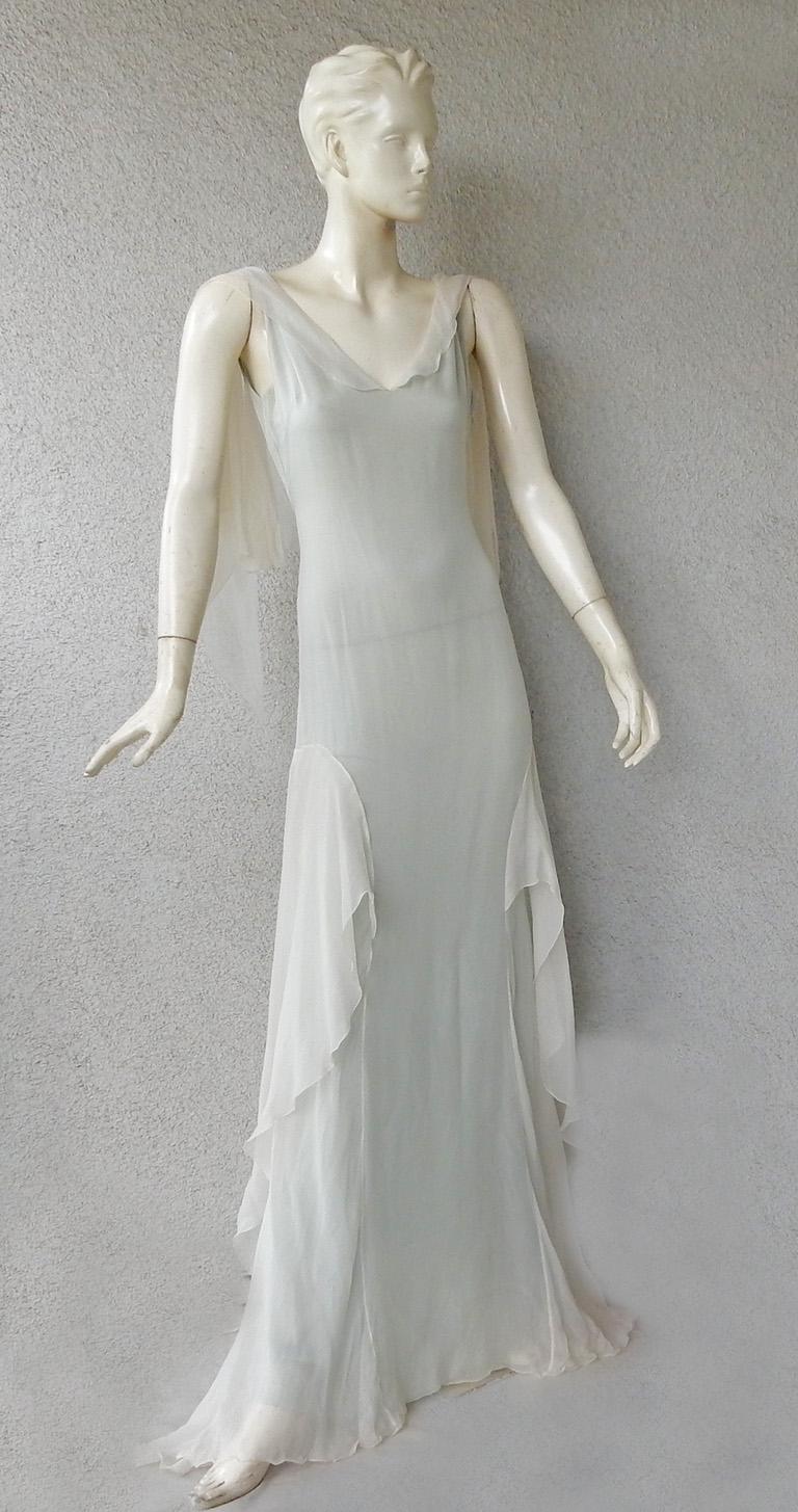 Emanuel Ungaro dreamlike evening dress fashioned of layers of silk chiffon.   Shade is a very soft pearl white with underdress of light blue.  So it creates an attractive visual  shade of soft blue gray.   One of the most stunningly beautiful