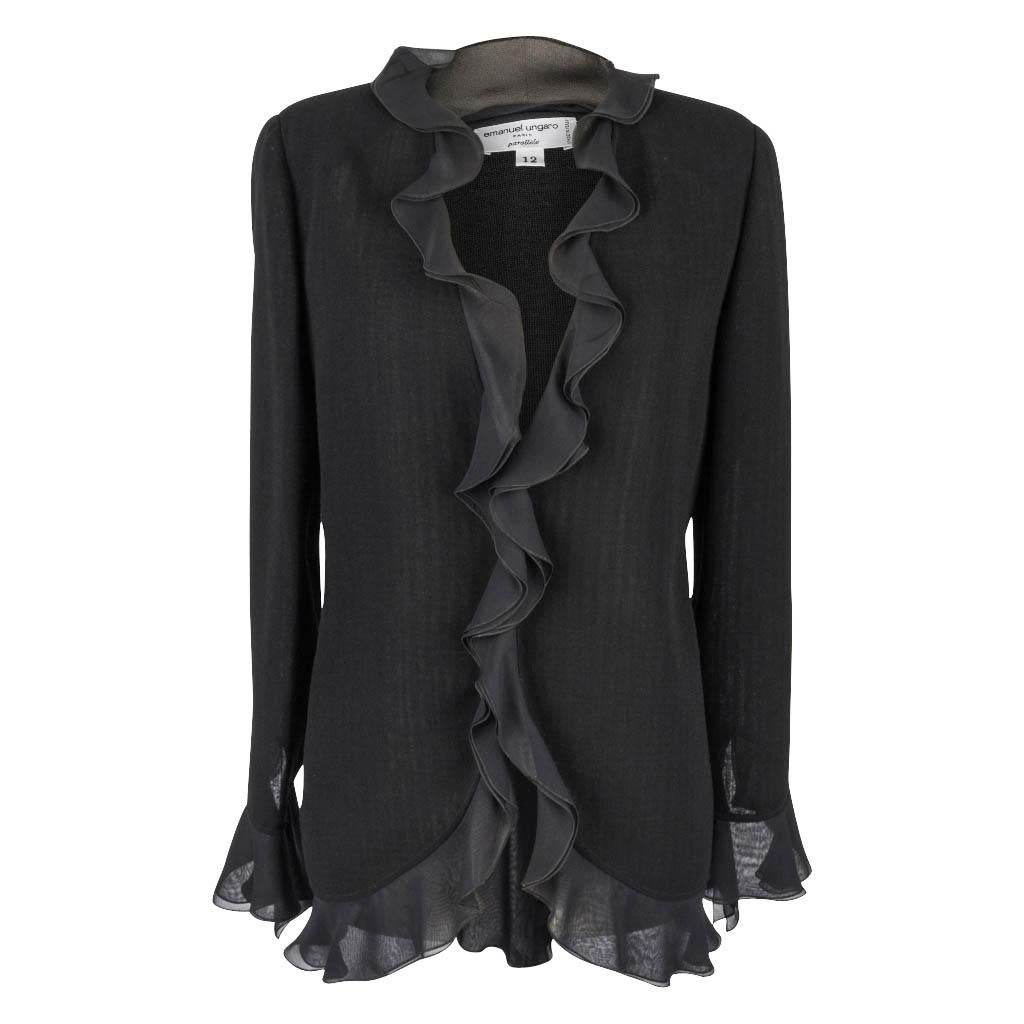 Guaranteed authentic Emanuel Ungaro fabulously chic set and all the right touches of soft ruffle this season calls for.  
Jet black wool jacket is trimmed in a wonderful undulating silk chiffon ruffle.
Three hidden buttons with a deep V-neck, this