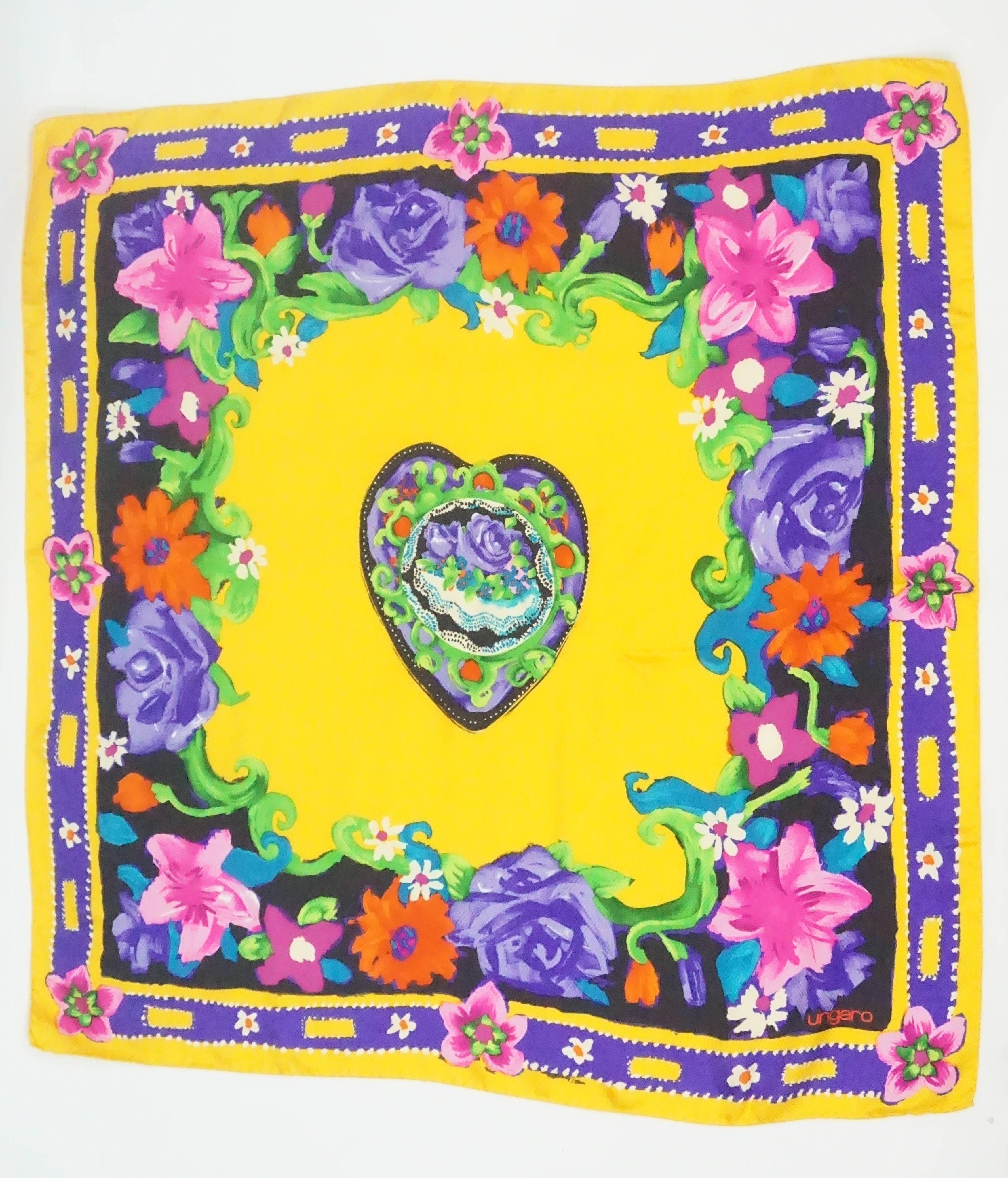 Emanuel Ungaro Multi Floral Print Textured Silk Scarf  This Ungaro silk scarf is a mixture of bright yellow, purple, pink, green, orange, and blue colors. There is a floral print throughout with a heart in the middle that has intricate designs
