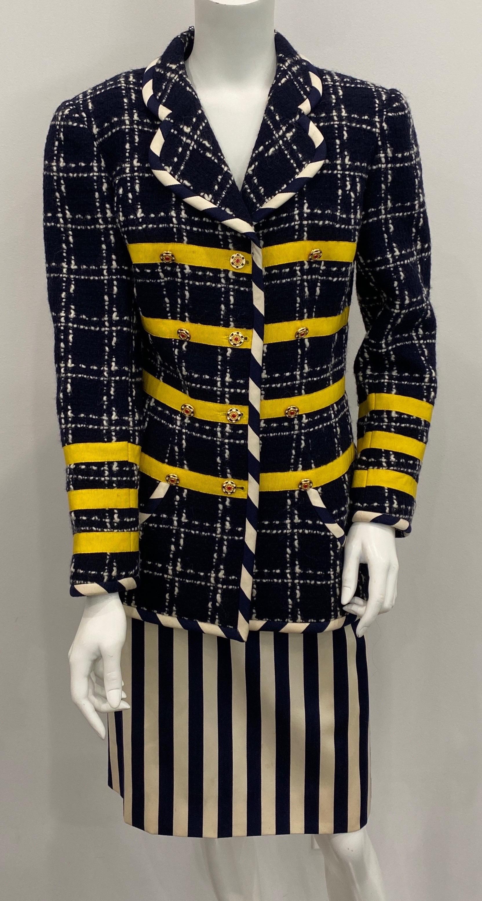 This vintage 1990’s Navy Boucle Jacket has white stitching throughout making a large checkered pattern. The jacket also has 3 yellow grosgrain ribbon making horizontal rows along the front and sleeve. The fully lined jacket is trimmed in a navy and